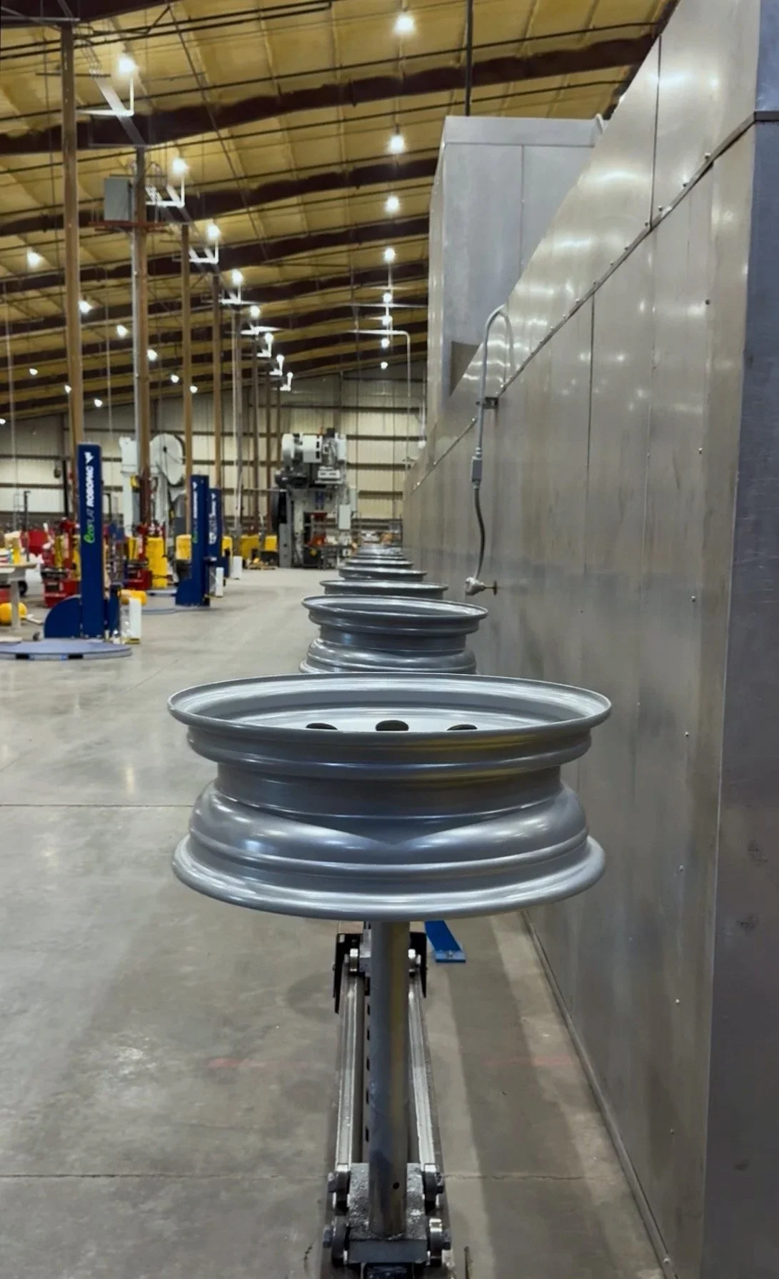 Silver steel wheels at the end of the painting process before being taken off the line for packaging