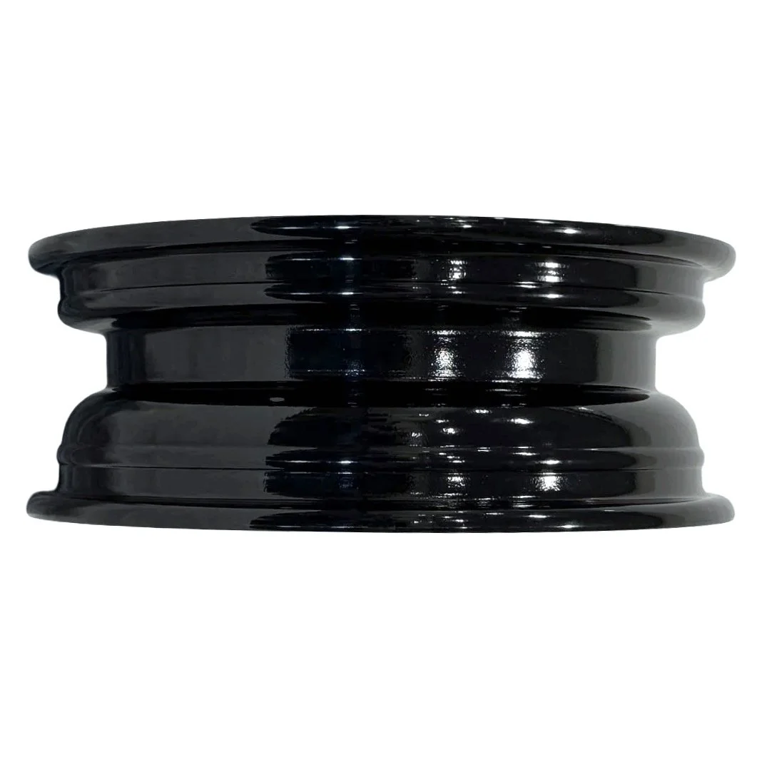 Black painted steel trailer wheel laying on its side