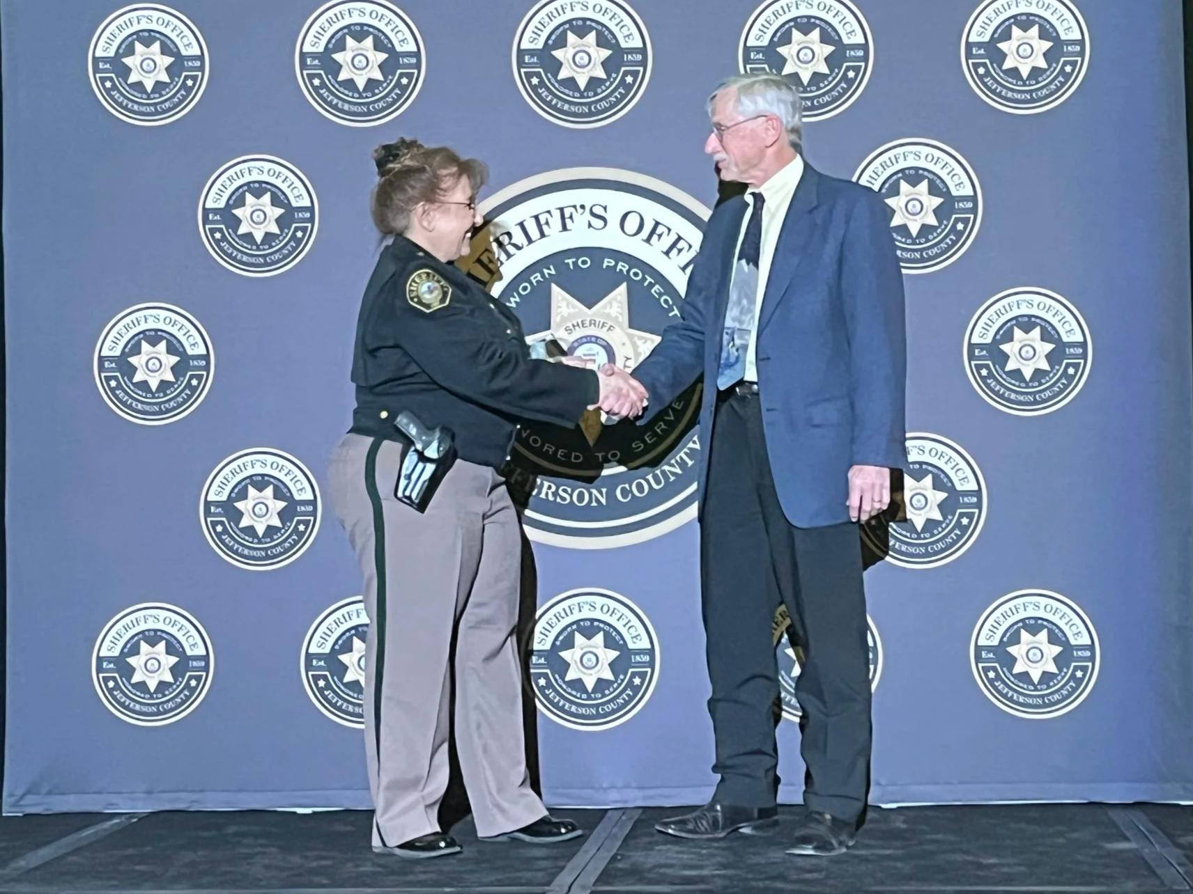 Jeffco Sheriff Marinelli presents Frank Blaha of the EET with the 2024 Community Partnership Non-Profit of the Year Award - March, 2025
