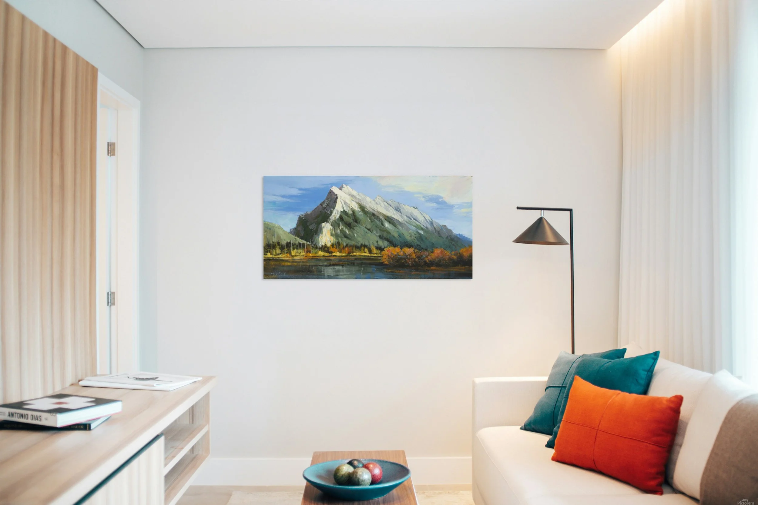 Mount Rundle Peak by Martin Pryce, unsigned stretched-canvas print on a living-room wall beside a floor lamp and white sofa