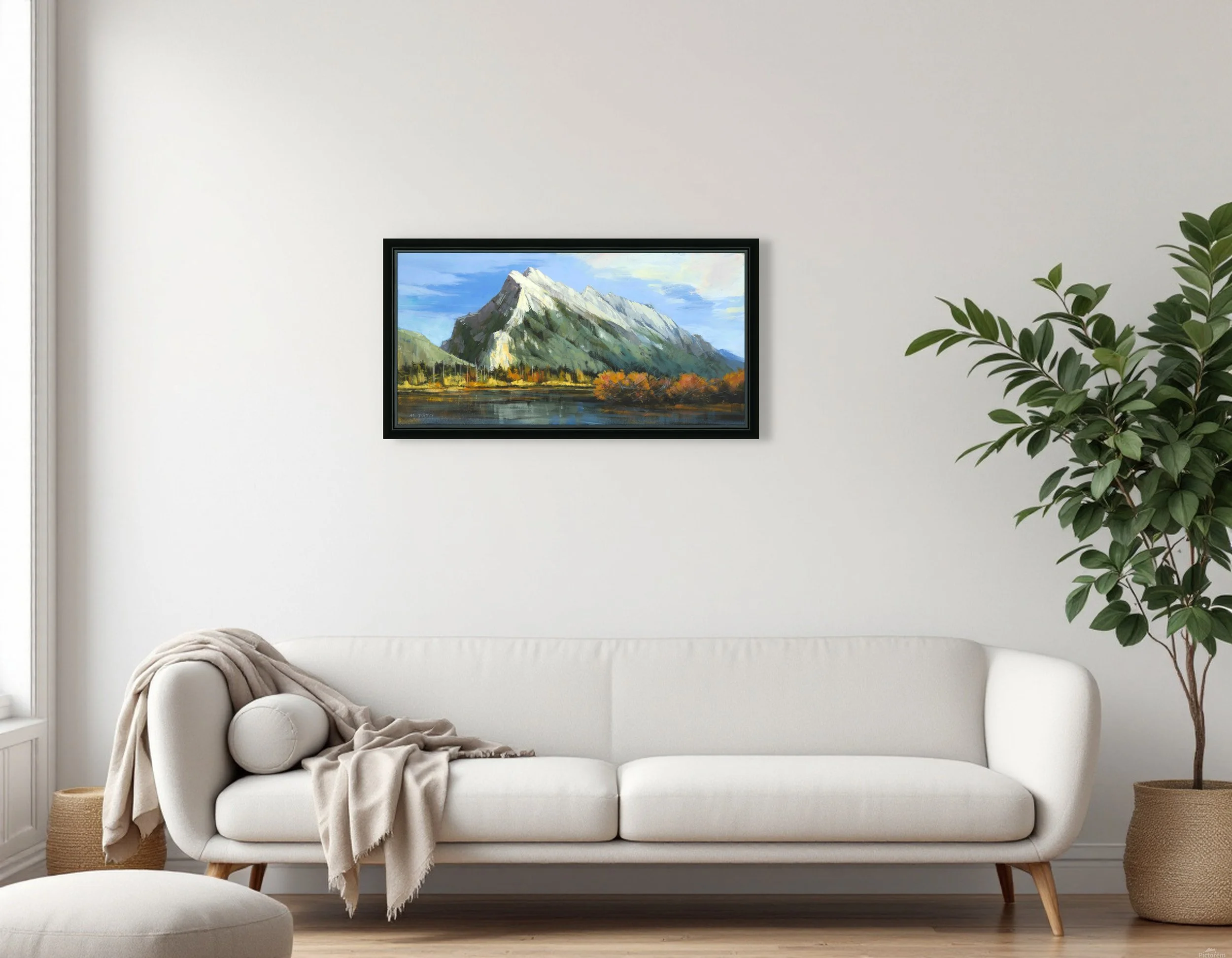 Mount Rundle Peak by Martin Pryce, unsigned framed canvas print in a black floating frame above a light grey sofa