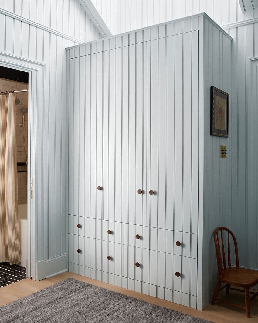 Custom light blue tongue-and-groove wardrobe in a child's bedroom in a Philadelphia home by Vestige Home