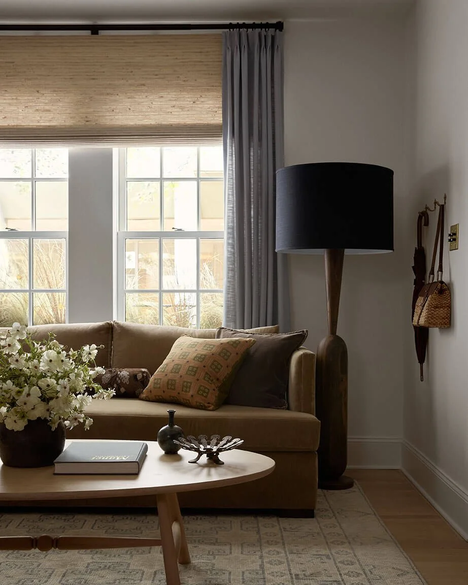 Camel velvet sofa and sculptural black floor lamp in a Philadelphia living room by interior designer Vestige Home