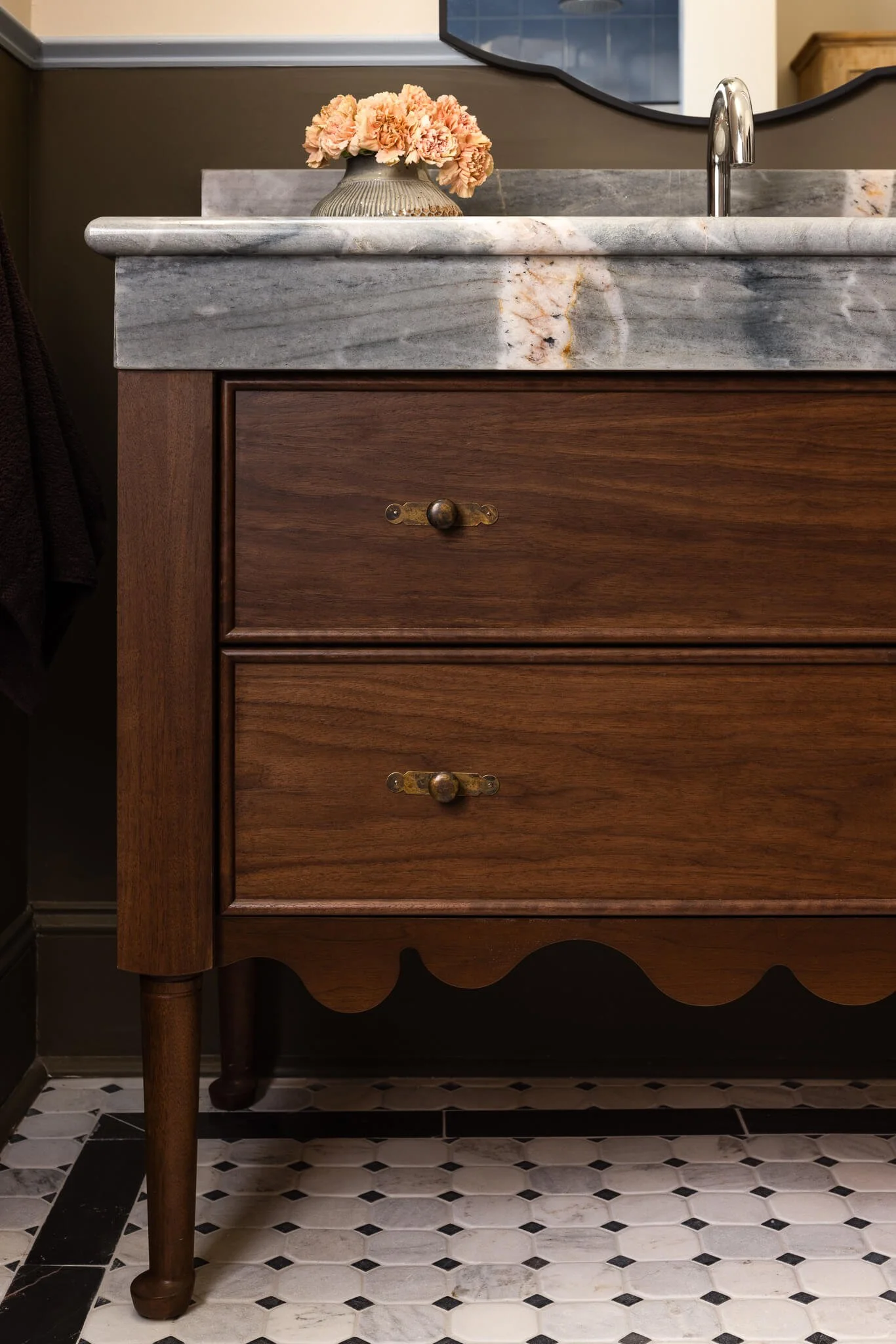Tailored vanity cabinetry with stone top and classic detailing in a Penn Valley, PA luxury bathroom remodel.
