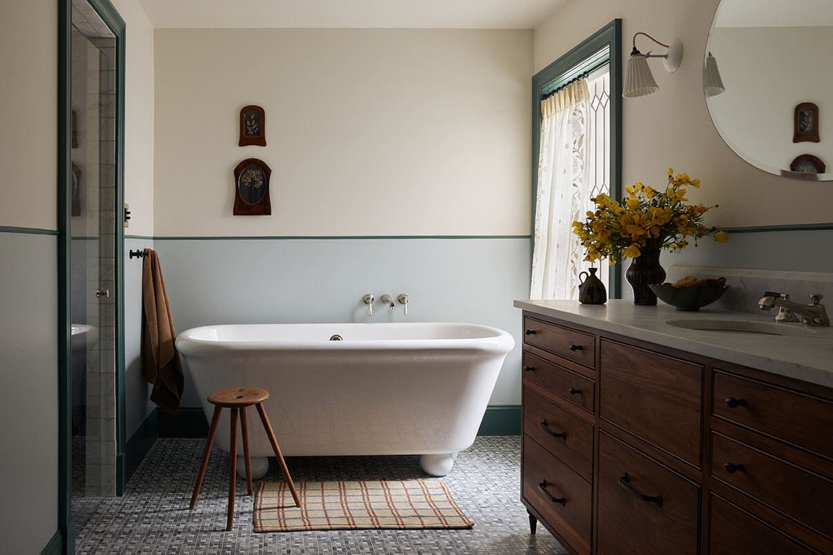 Luxury primary bathroom in Philadelphia by Vestige Home with a freestanding tub, walnut vanity and mosaic marble floor