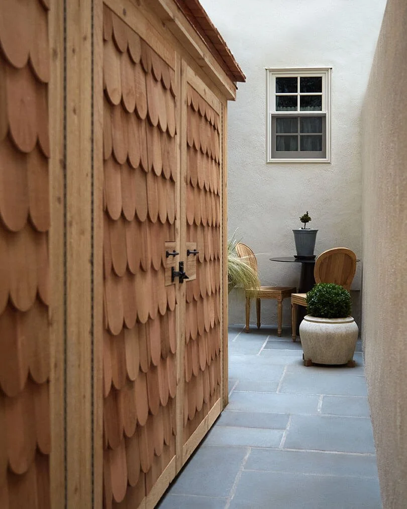 Cedar shake-shingled exterior and bluestone courtyard of a Philadelphia rowhouse renovated by Vestige Home