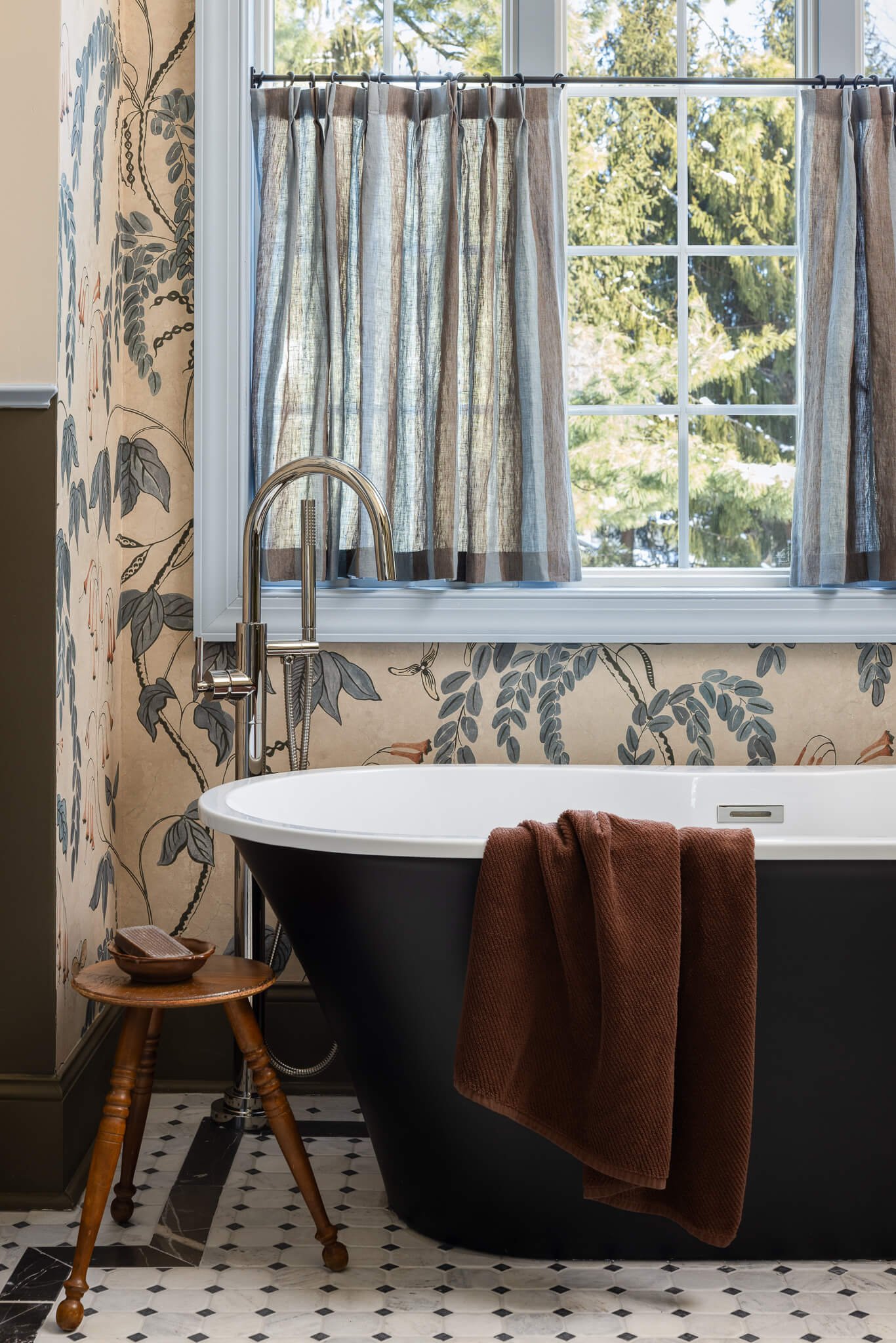 Freestanding tub detail with vintage-inspired fixtures and tailored window treatments in a Penn Valley, PA luxury bathroom.