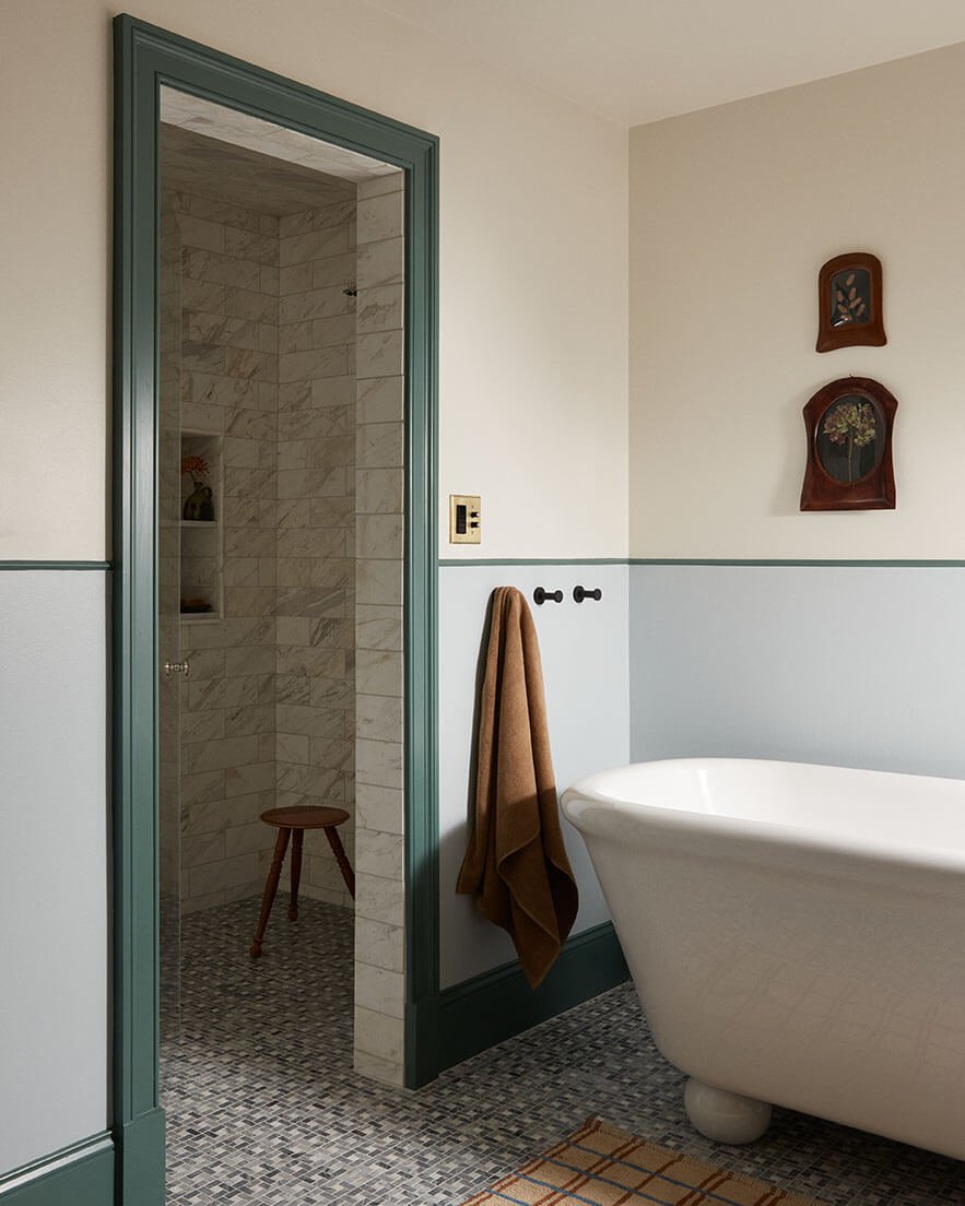 Marble-tiled walk-in shower and freestanding tub in a luxury Philadelphia bathroom by Vestige Home