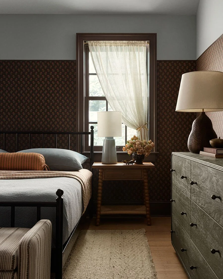 Black metal bed, spindle nightstand and burl dresser in a moody Philadelphia bedroom by Vestige Home