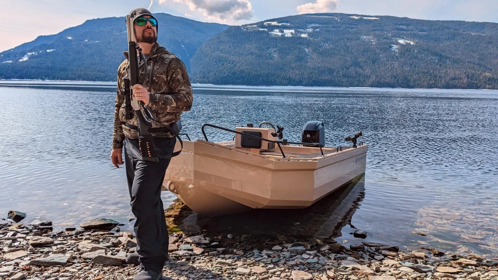 The owner of Fish Whistle Boats posing near his boat while out on a hunting trip