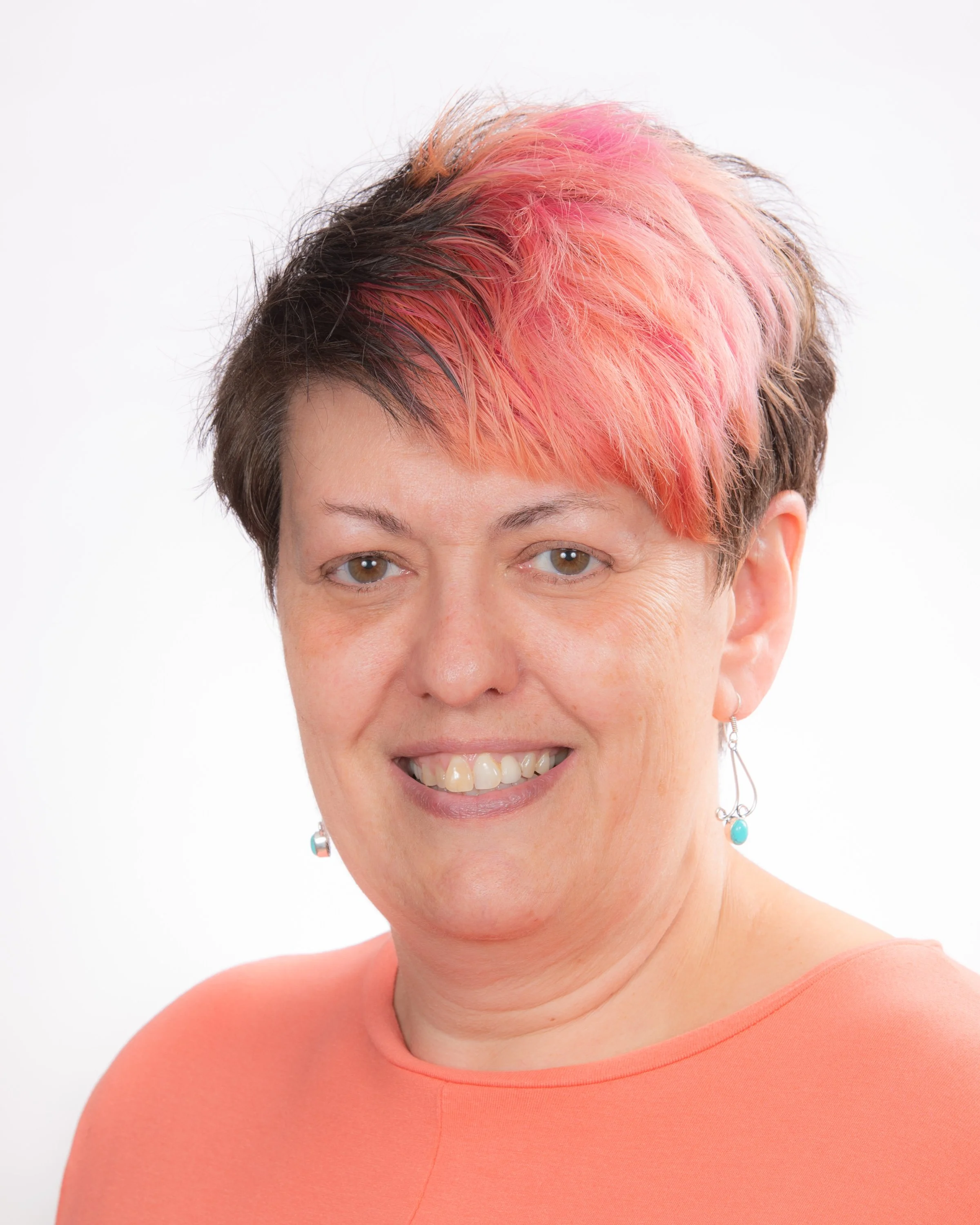 Person in police uniform standing in front of American flag.