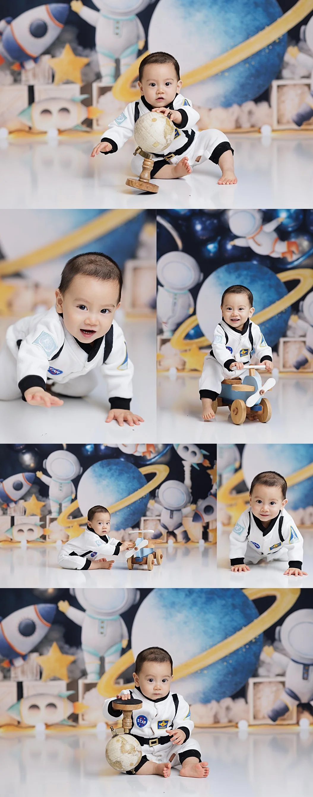 Baby boy astronaut themed first birthday portrait playing with wooden airplane toy