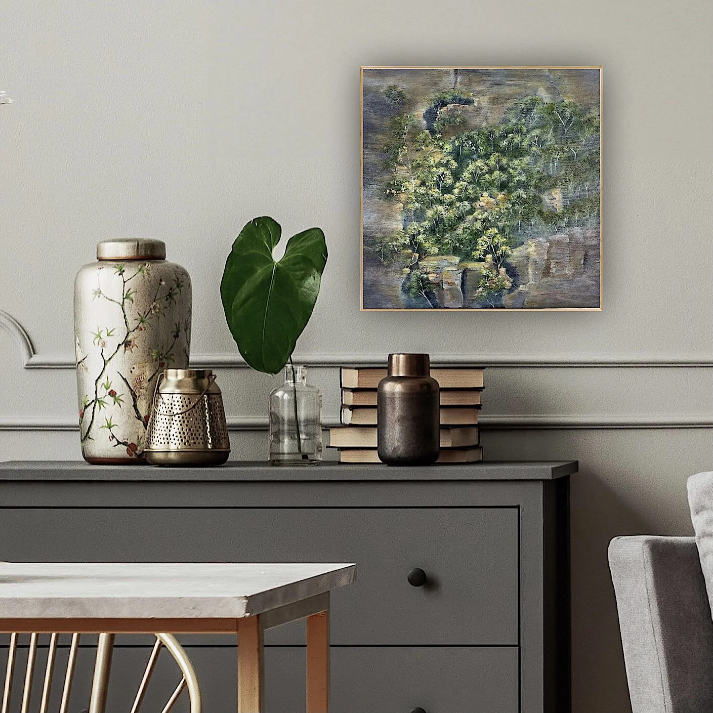 In-room view of 'Living on a Ledge', an original Blue Mountains acrylic painting of gum trees by Vivian Kohring Artist, hanging framed on a living room wall