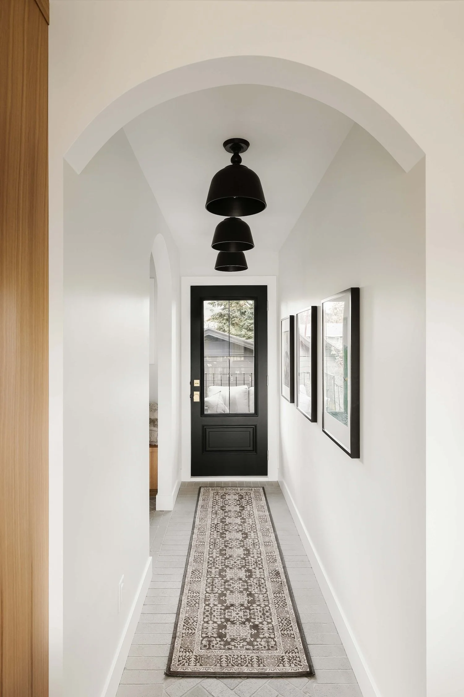 white hallway with black door