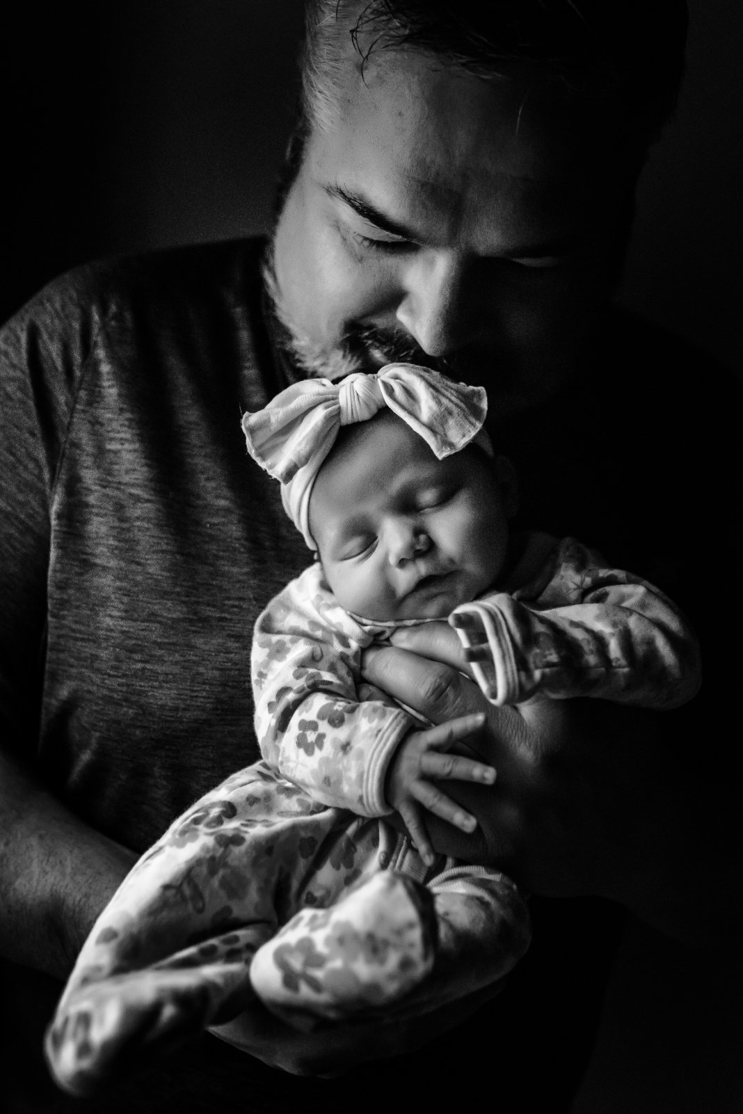 tender newborn embrace with dad and baby for in home newborn photos in wausau wisconsin