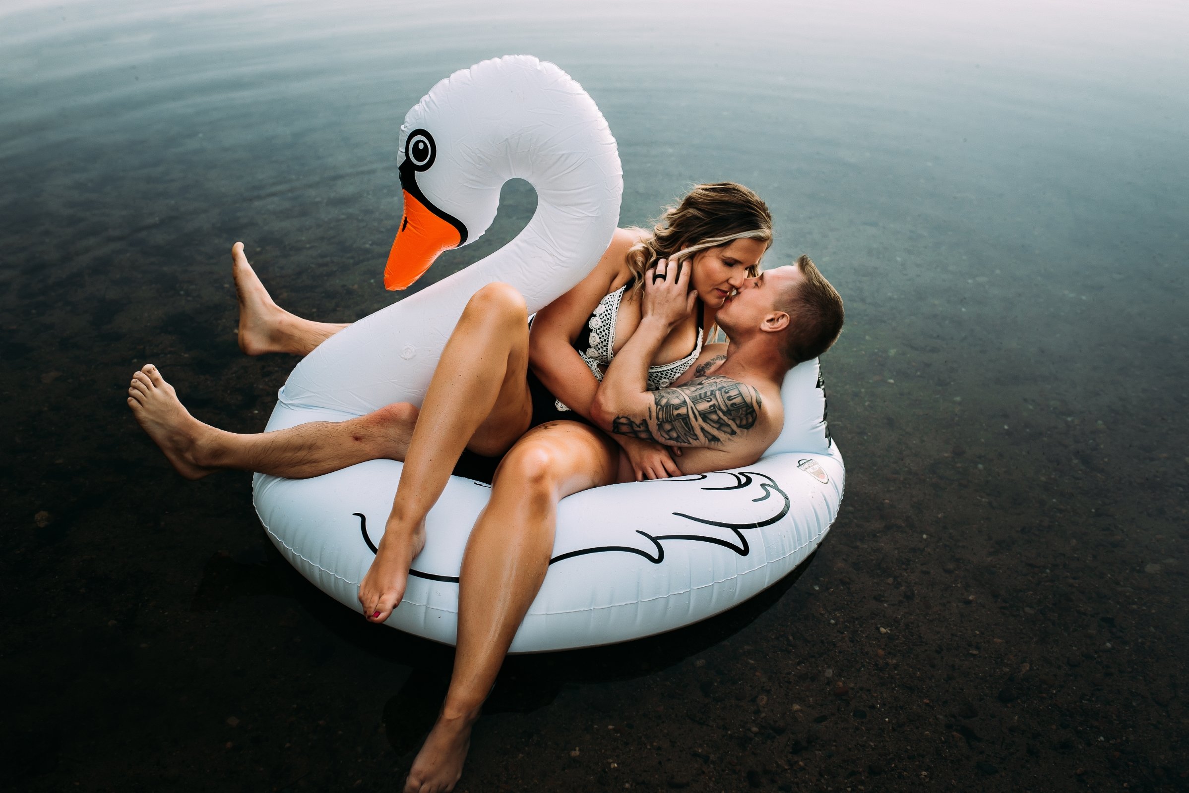 unique couple in water at wausau lake for engagement photos