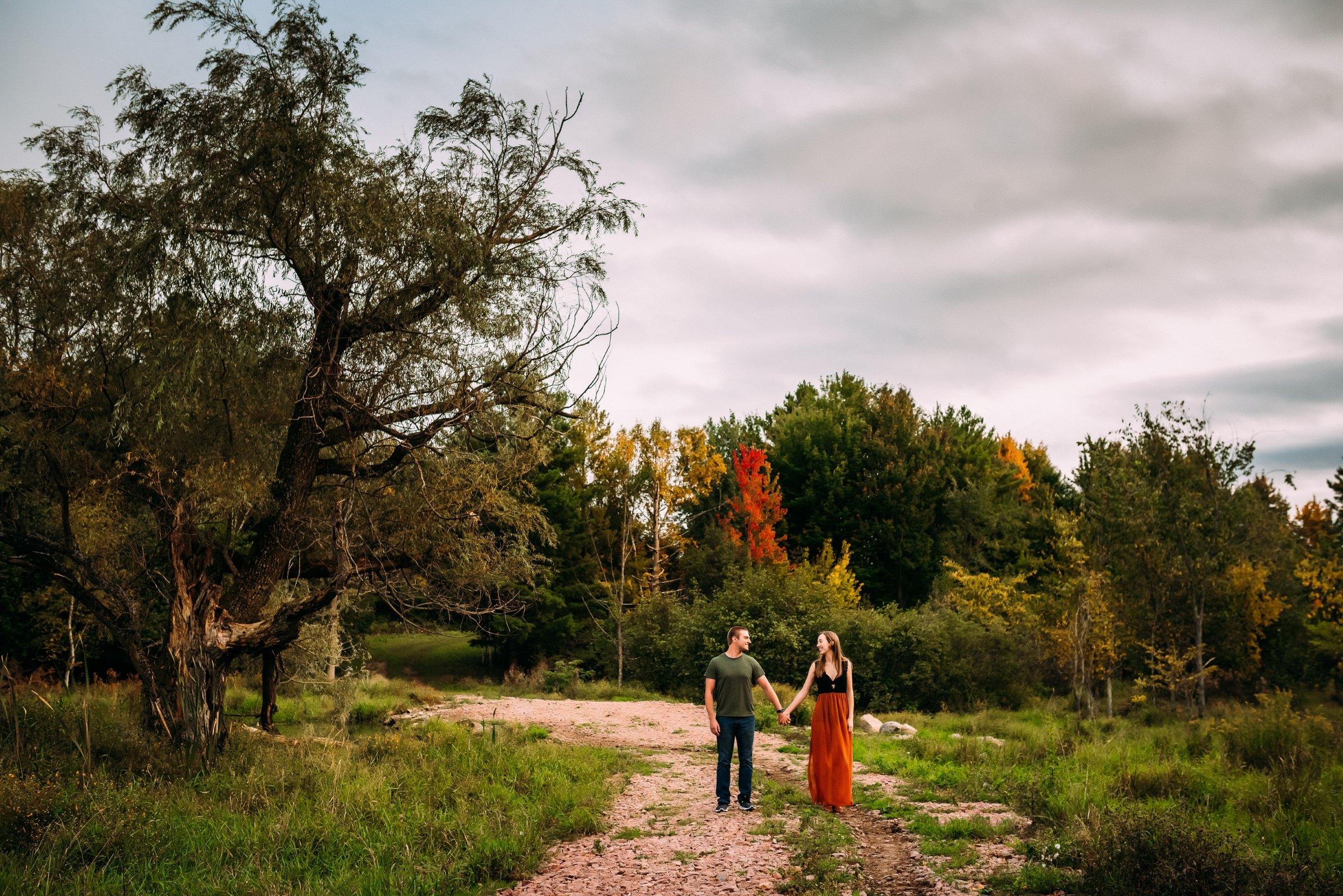 engaged couple embracing surrounded stunning wisconsin fall colors 