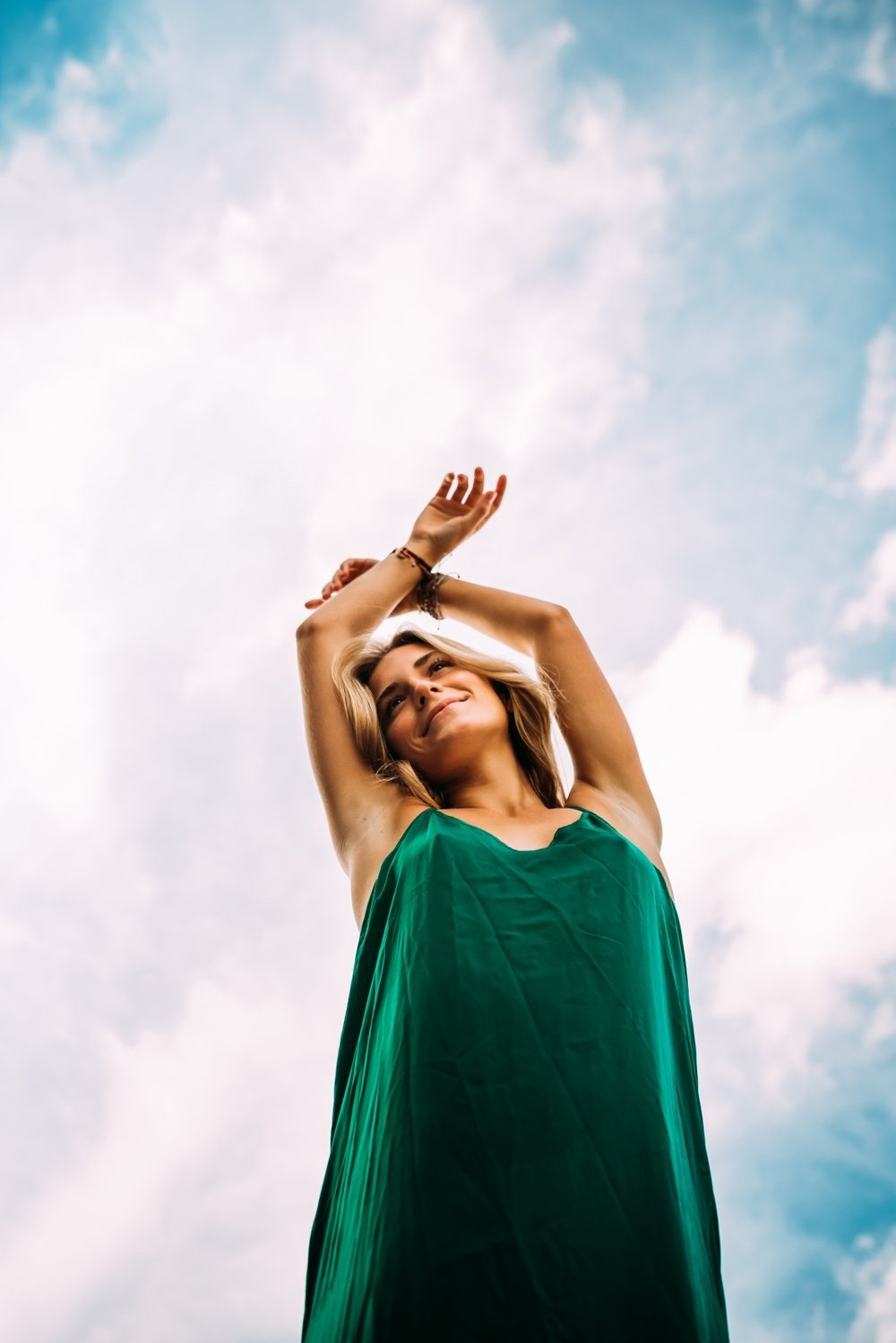 unique perspective of senior girl against blue sky