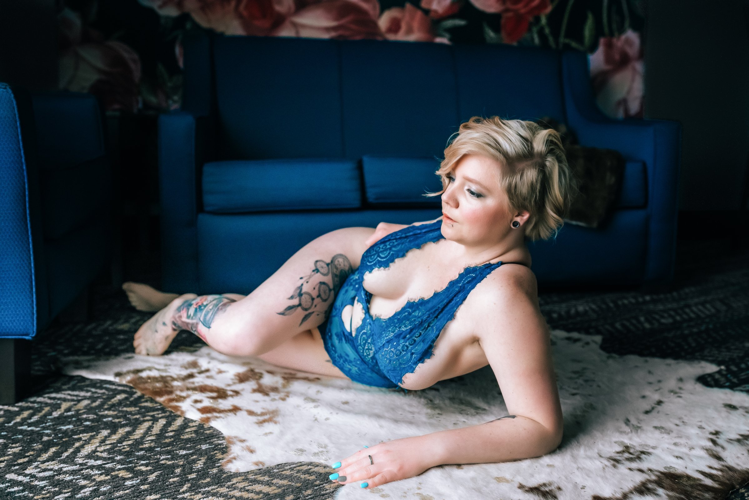 stunning women lays on rug for boudoir photos