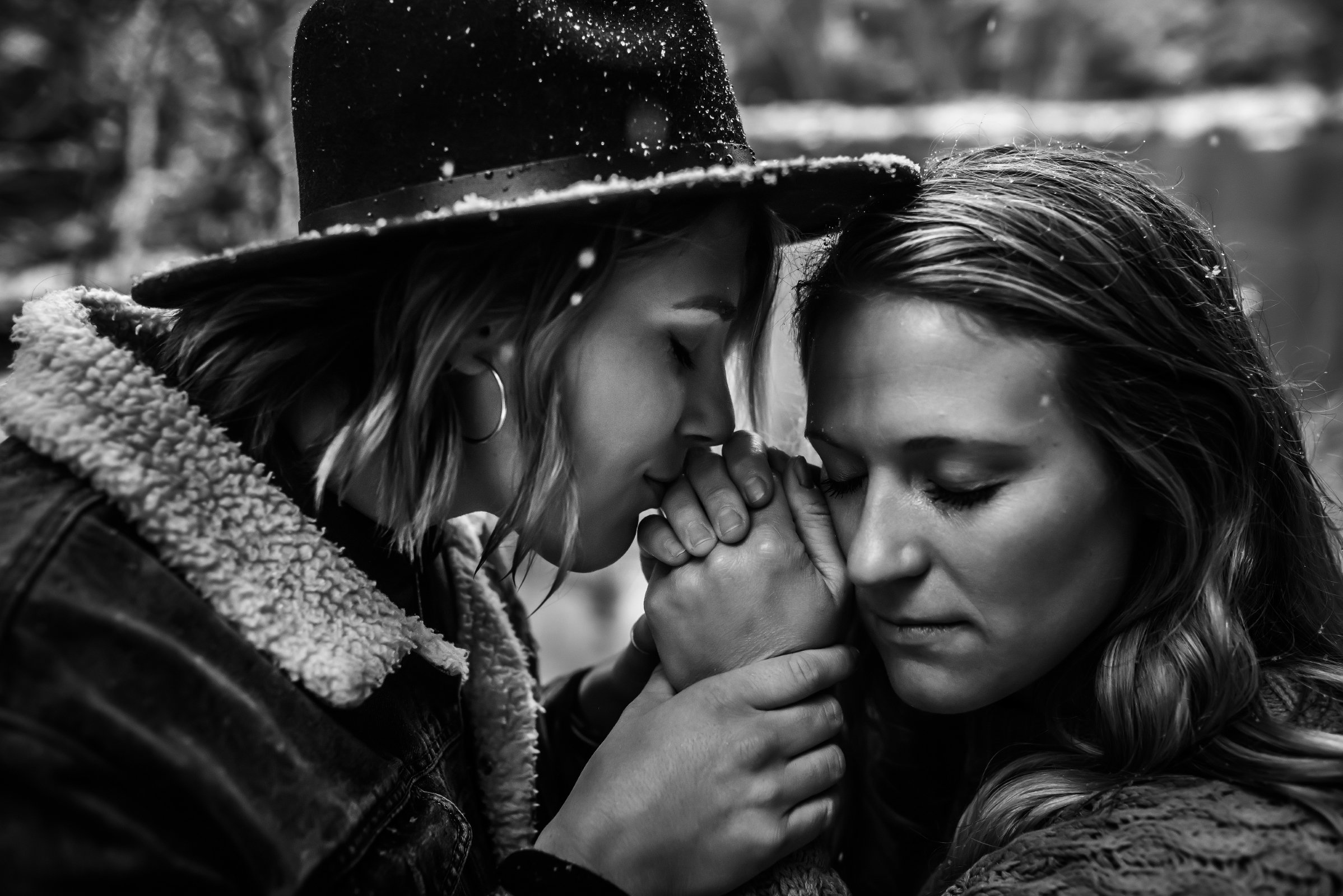 two women embrace during engagement photos