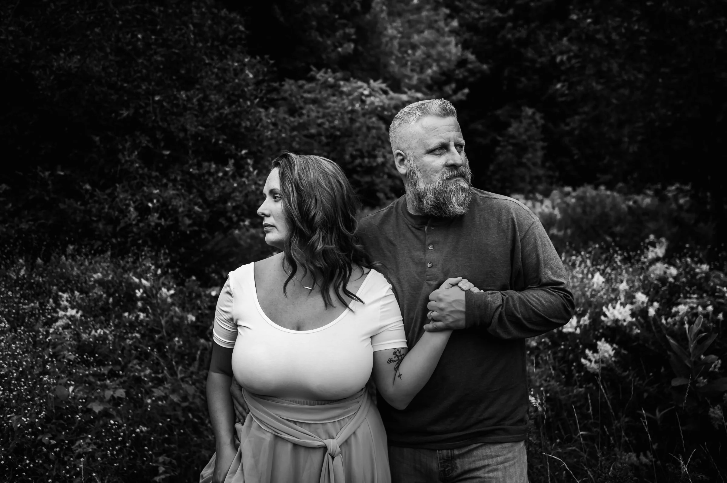 woman and husband holding hands in field