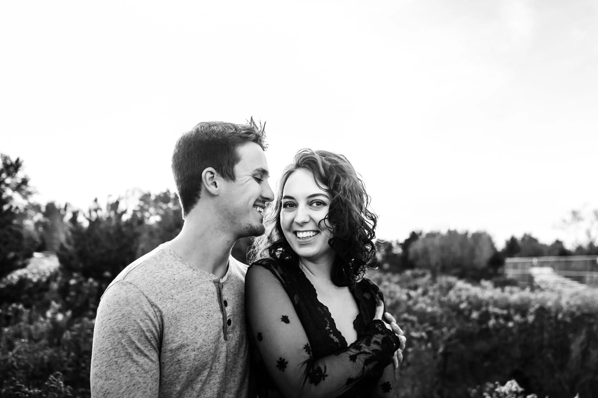 couple laughing and smiling at their engagement session in wausau wisconsin