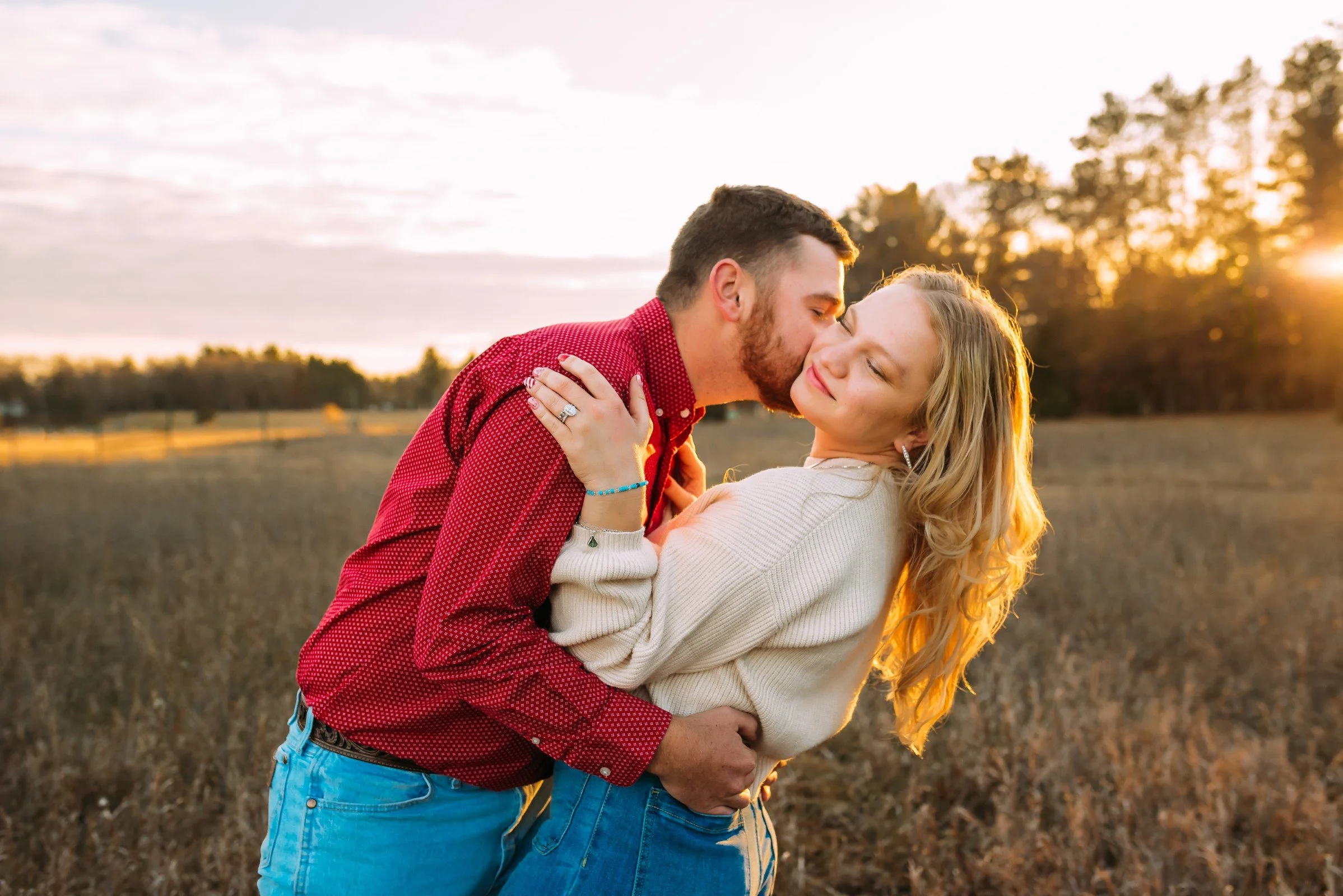 happy couple kissing in Wausau Wisconsin for engagement photos