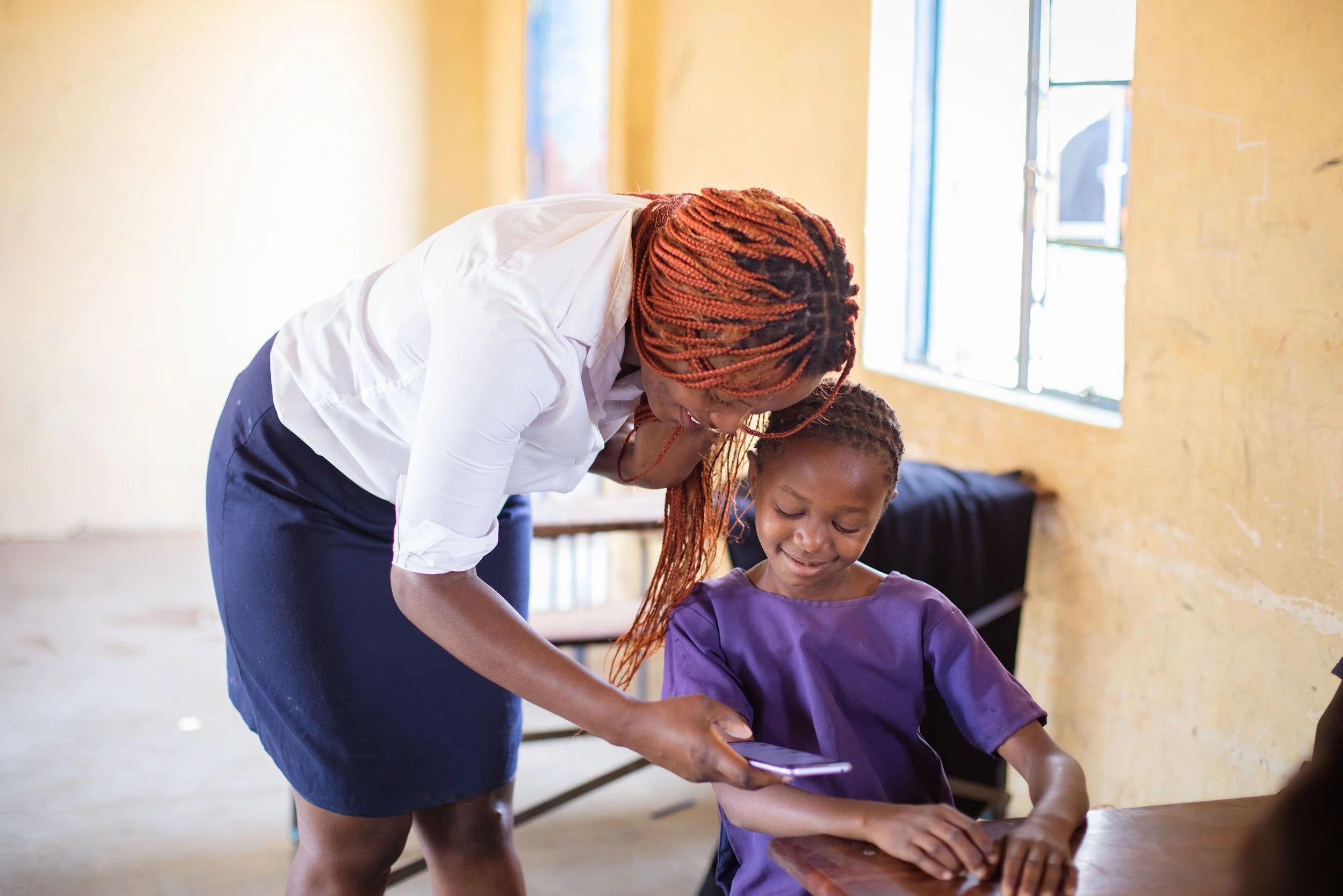 teacher showing learner phone (1).JPG