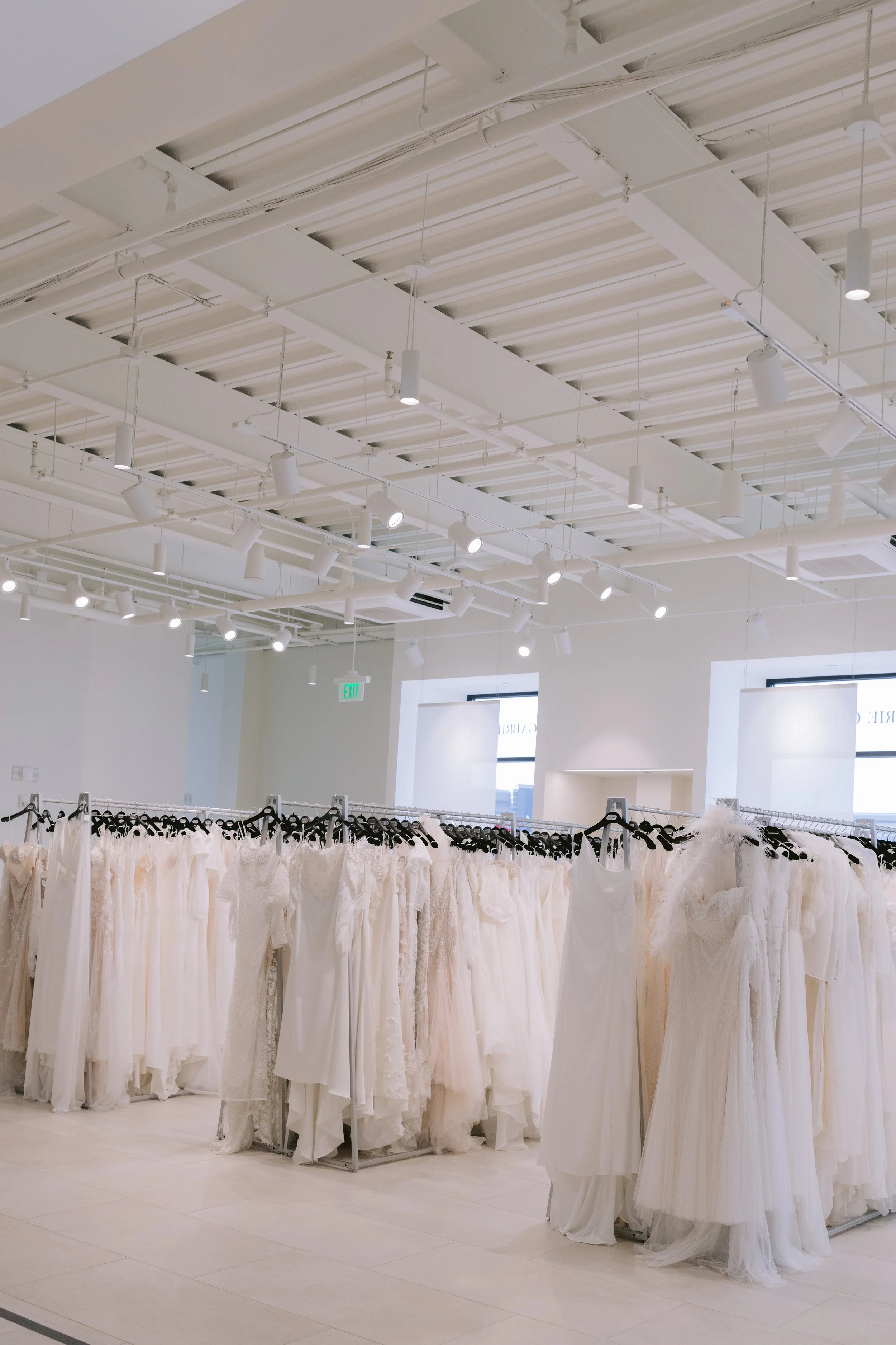 Wedding dresses hanging in Marie Gabriel Bridal, located in Indianapolis Indiana