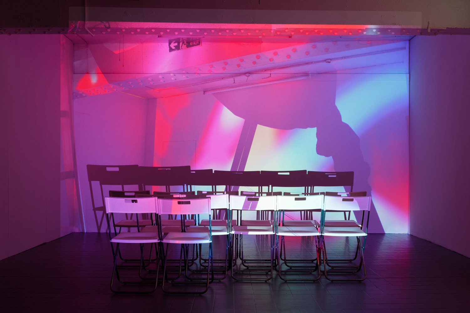 Assembly, 2016, projection (looped series of 147 stills for each of three projectors), chairs, dimensions variable