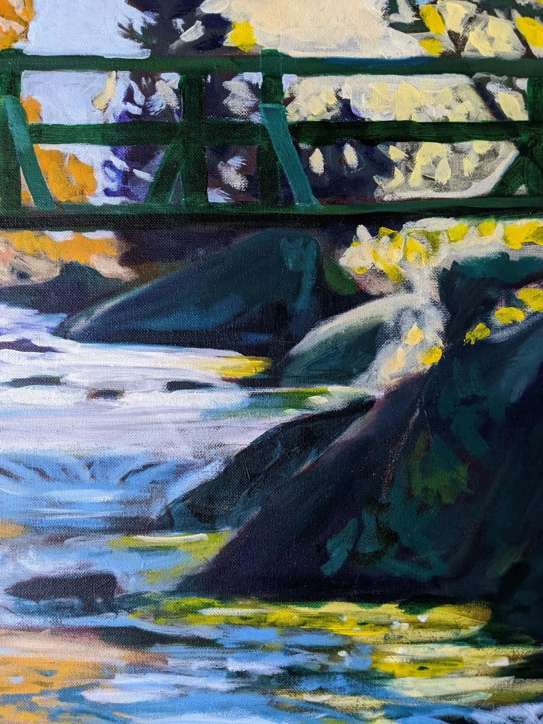 Painting of a river flowing under a green bridge with rocks and yellow flowers near the water.