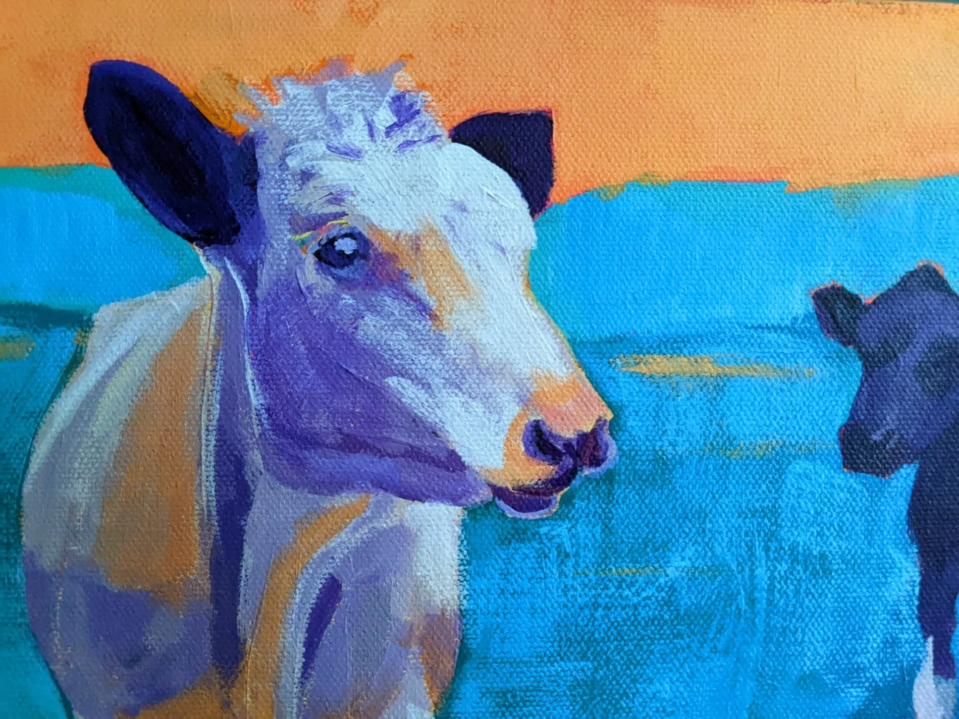 Colorful painting of two cows resting on a blue and orange background.
