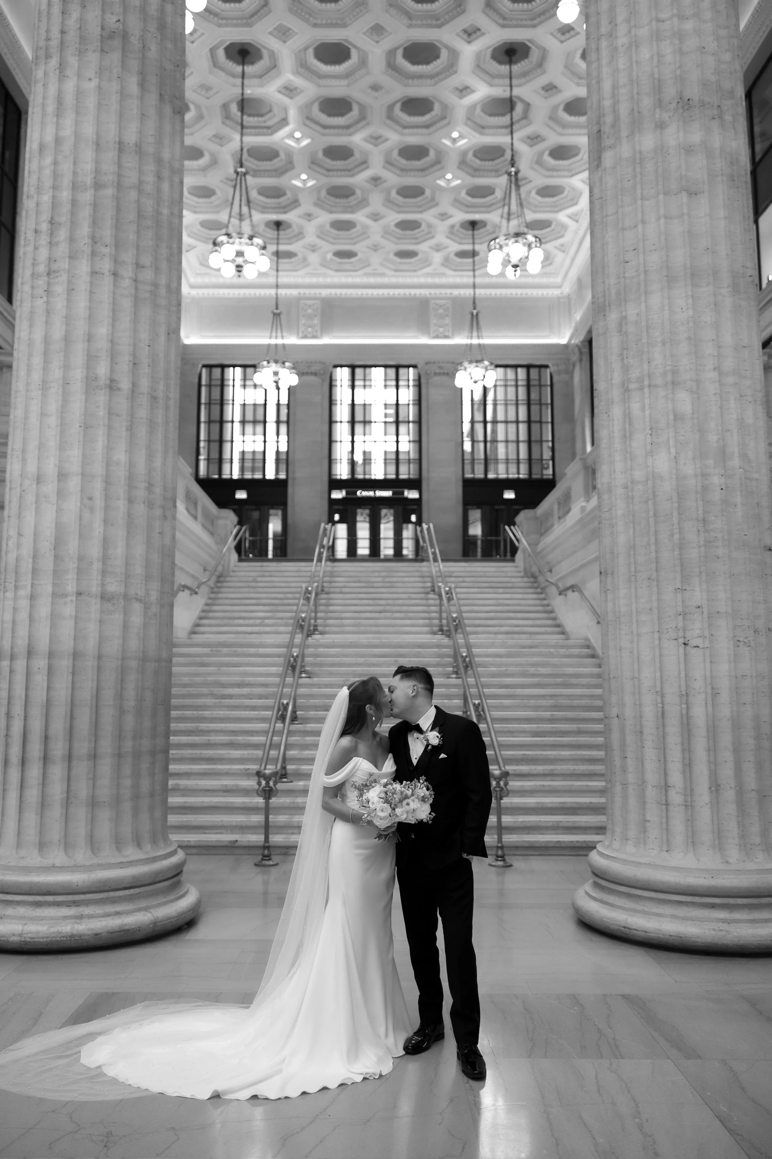 Union Station Chicago wedding couple kisses in front of staircase