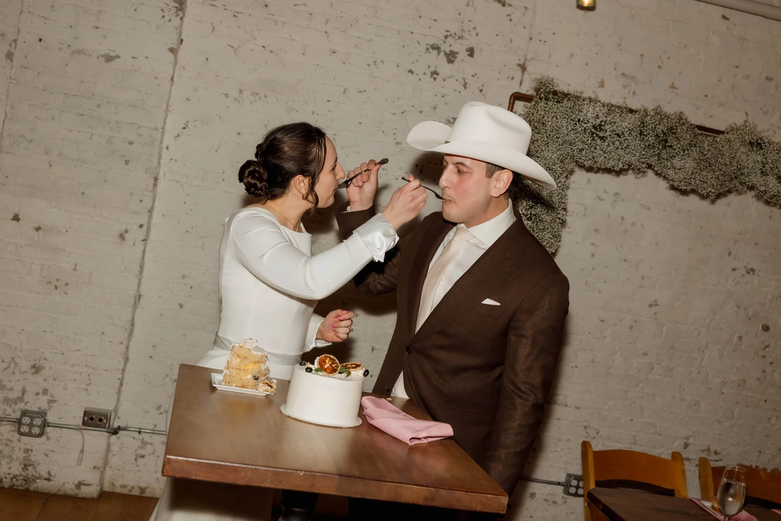 Bride and groom cut their cake at The Joinery wedding reception