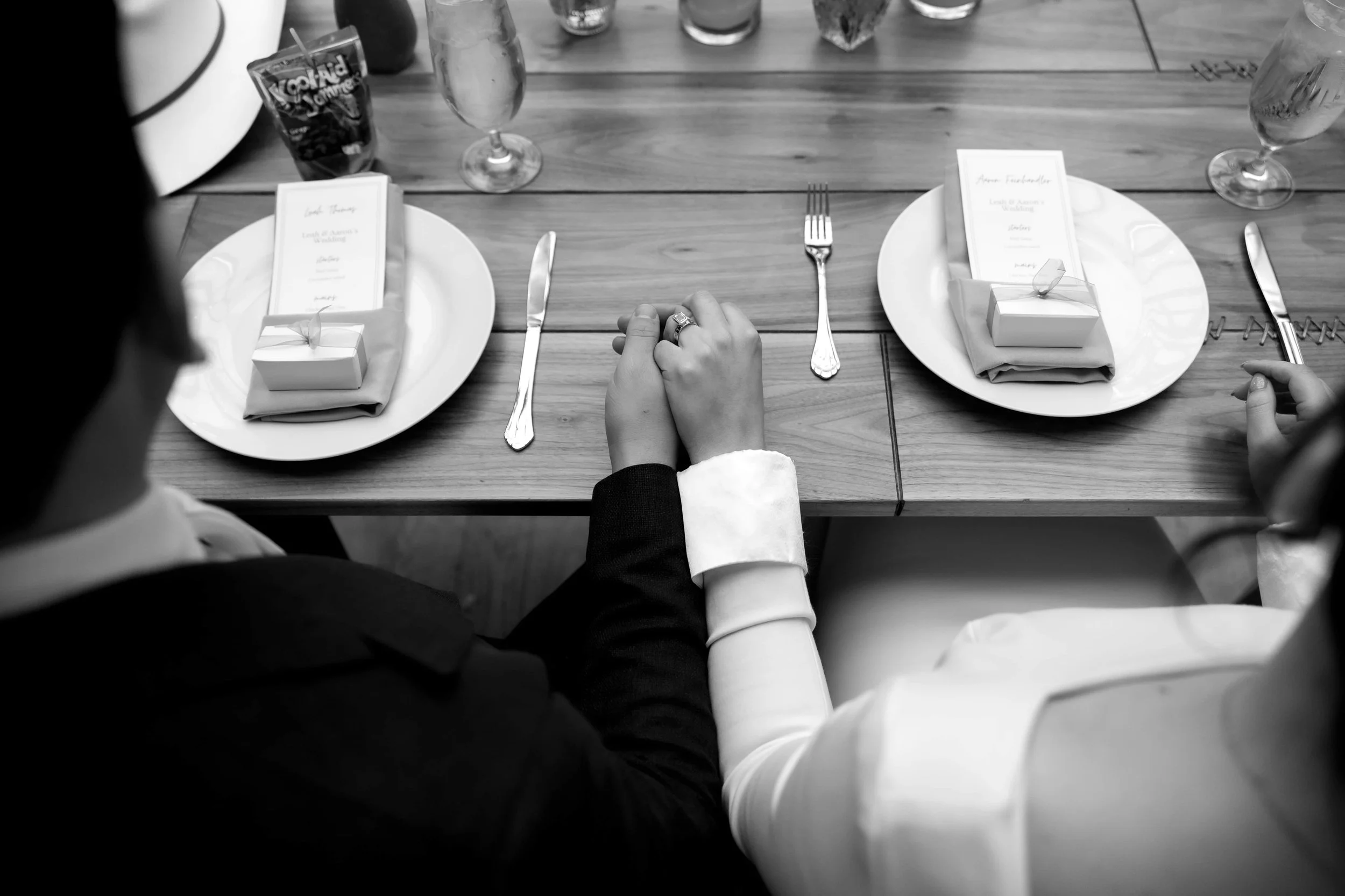 Bride and groom hold hands at their wedding reception at The Joinery