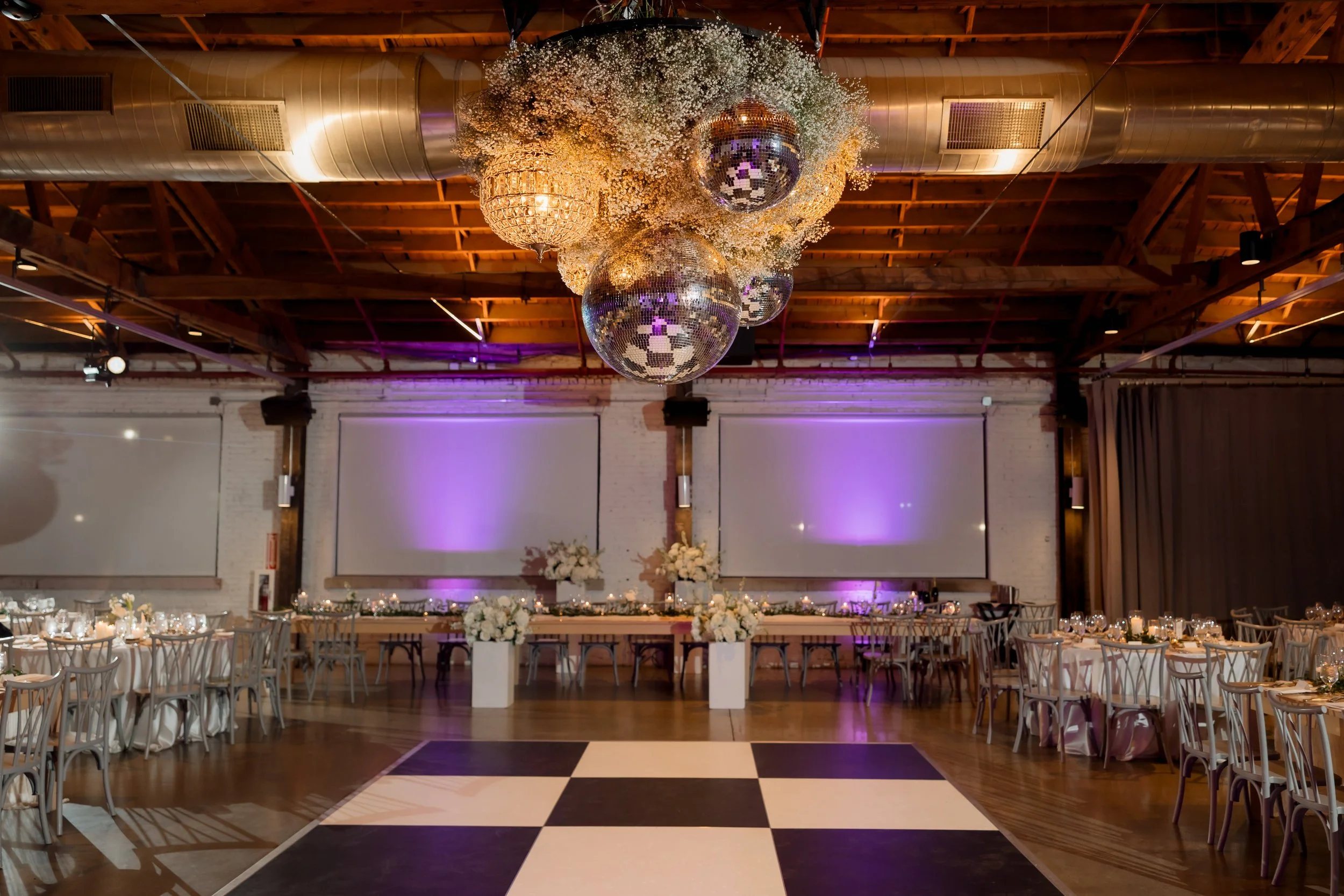 Disco ball and checkered dance floor wedding decor at Walden Chicago