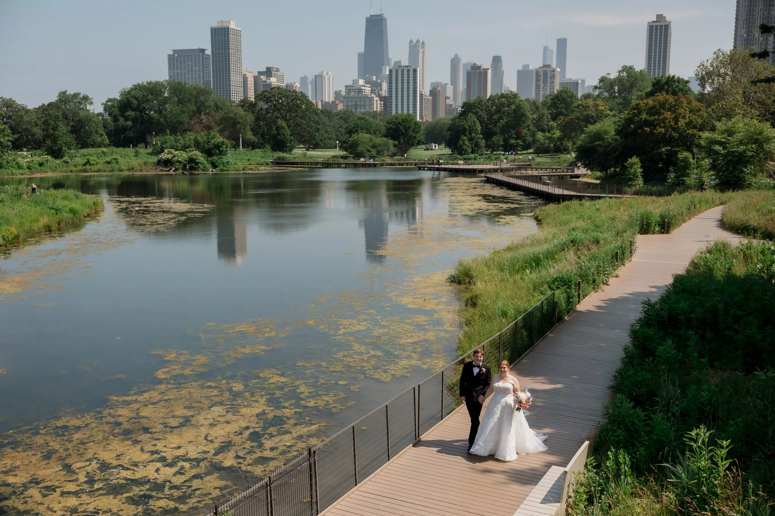 Bride and groom walking through downtown Chicago on wedding day