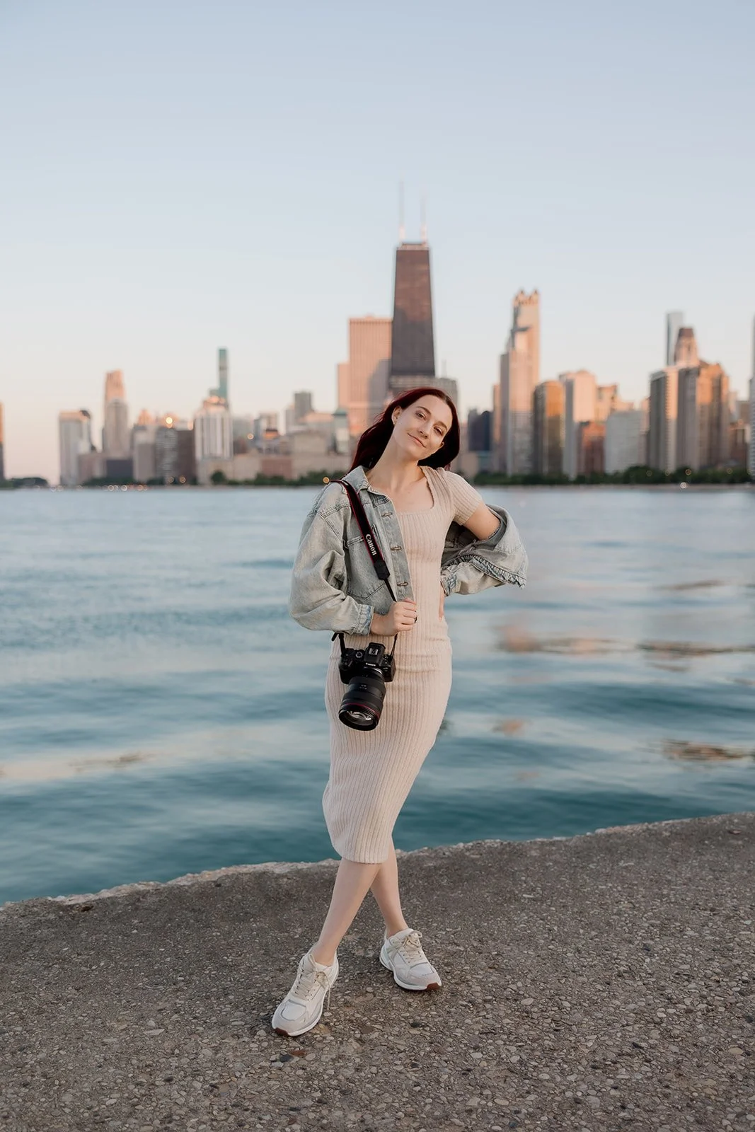 Headshot of Audrey Simper, a Chicago Wedding Photographer with the Chicago city skyline in the background at North Ave Beach