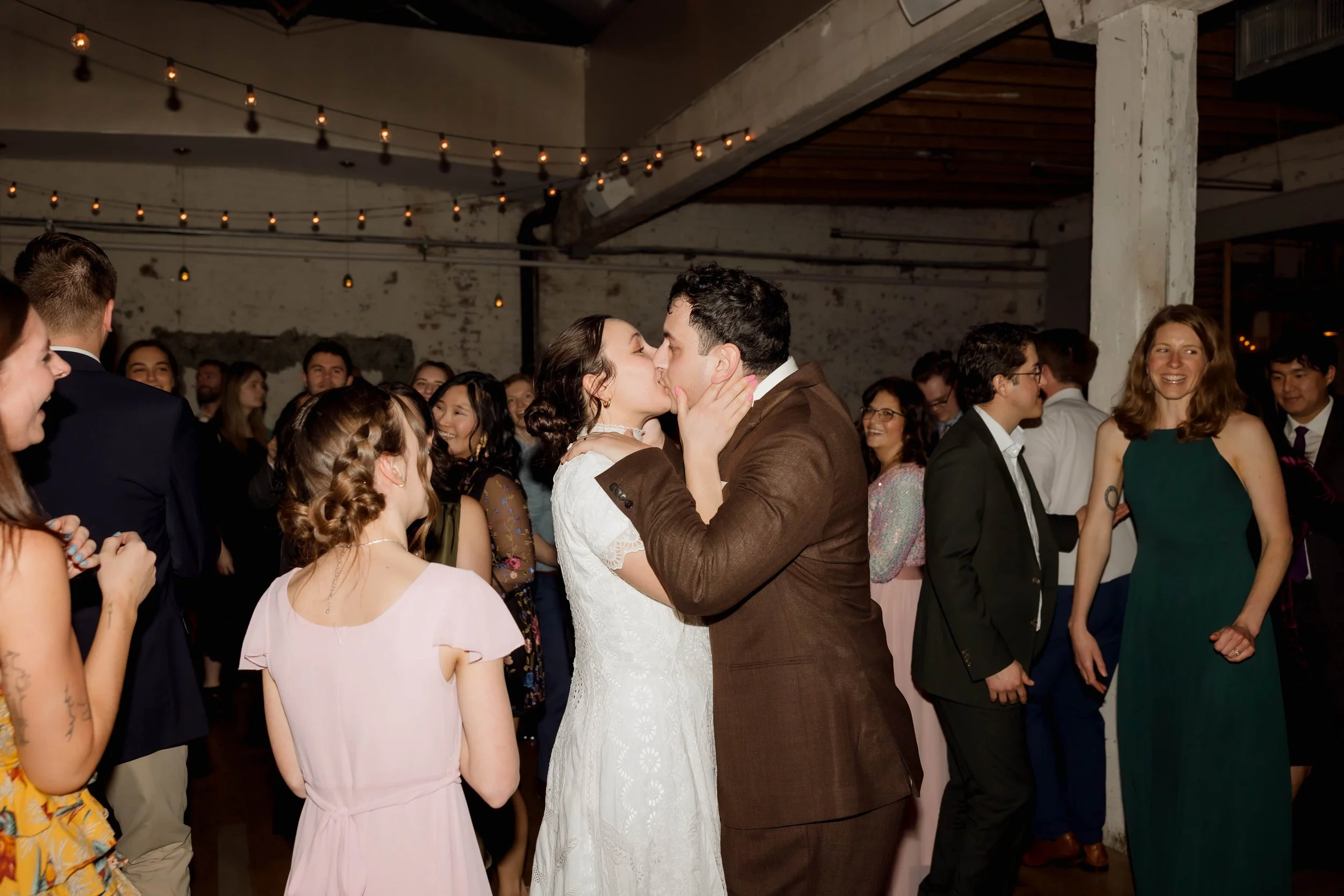 Bride and groom kiss on the dance floor at The Joinery