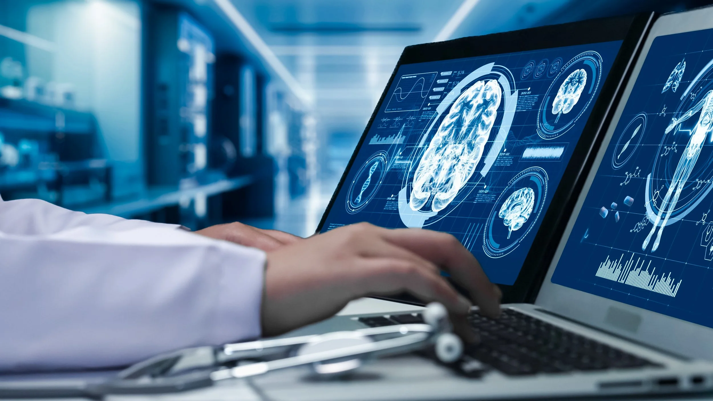 Close up of doctor working on tablet and laptop with brain mapping images