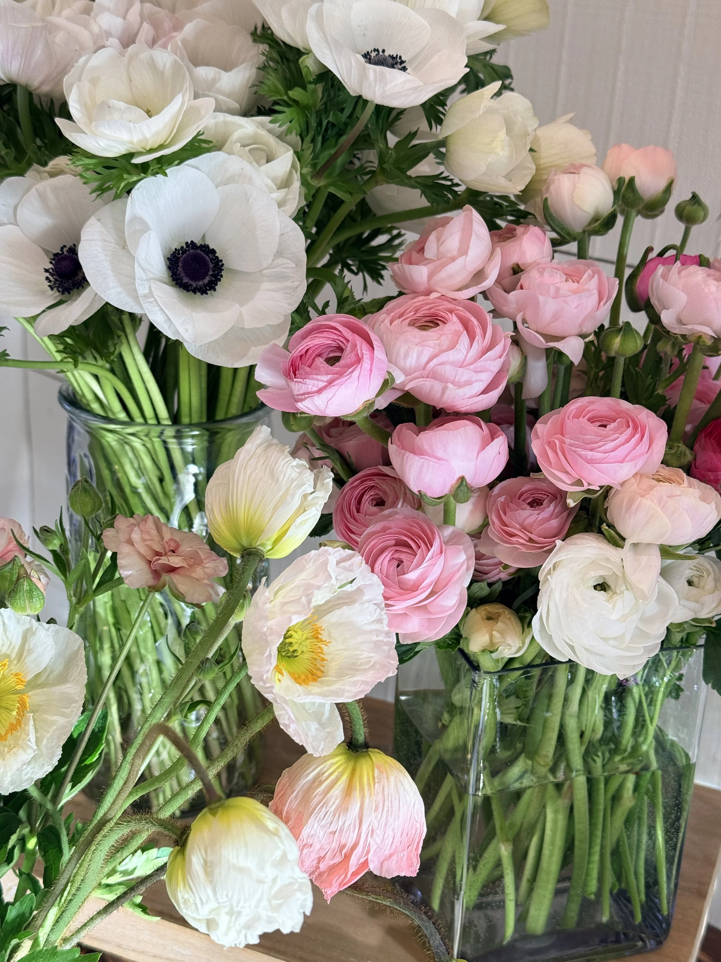 A bucket of bulk flowers being held by a farmer-florist 