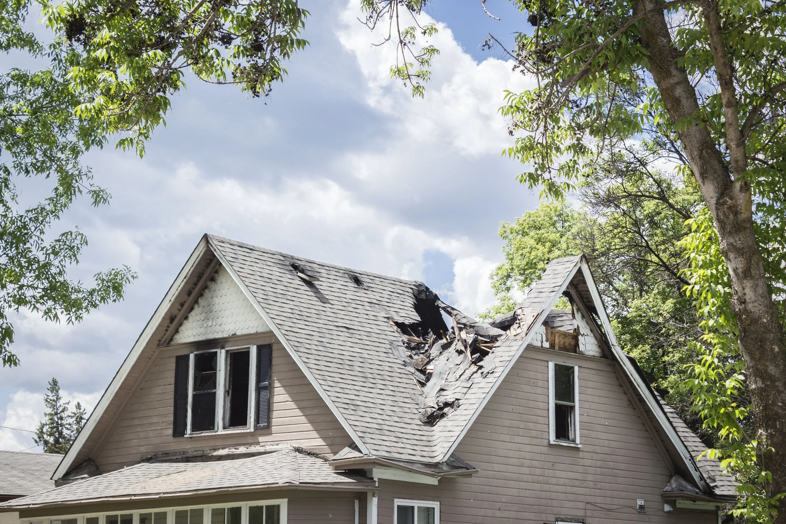 A public adjuster assessing roof damage from a hurricane in Houston, Texas.