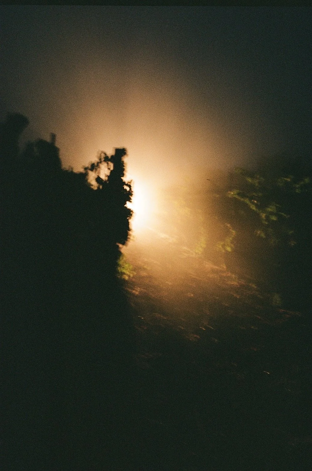 Nighttime scene of dark clouds with bright moonlight shining through.