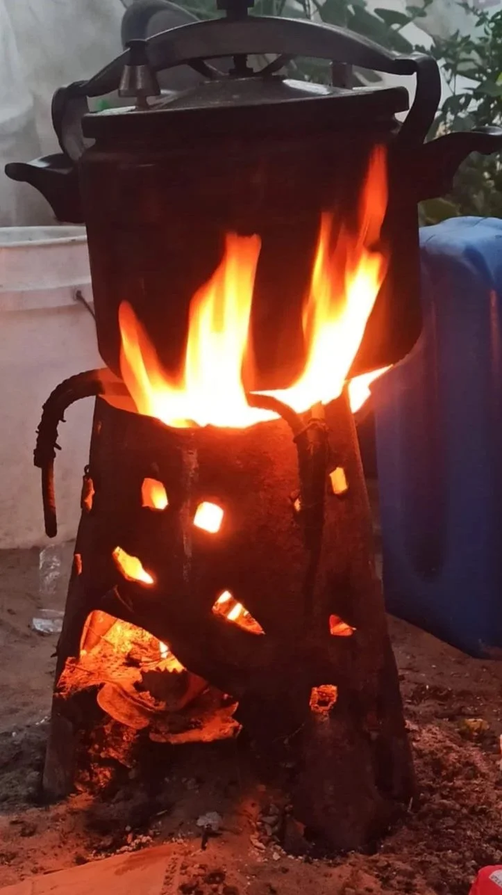 Make-shift stove, fire lit, with cooking pot