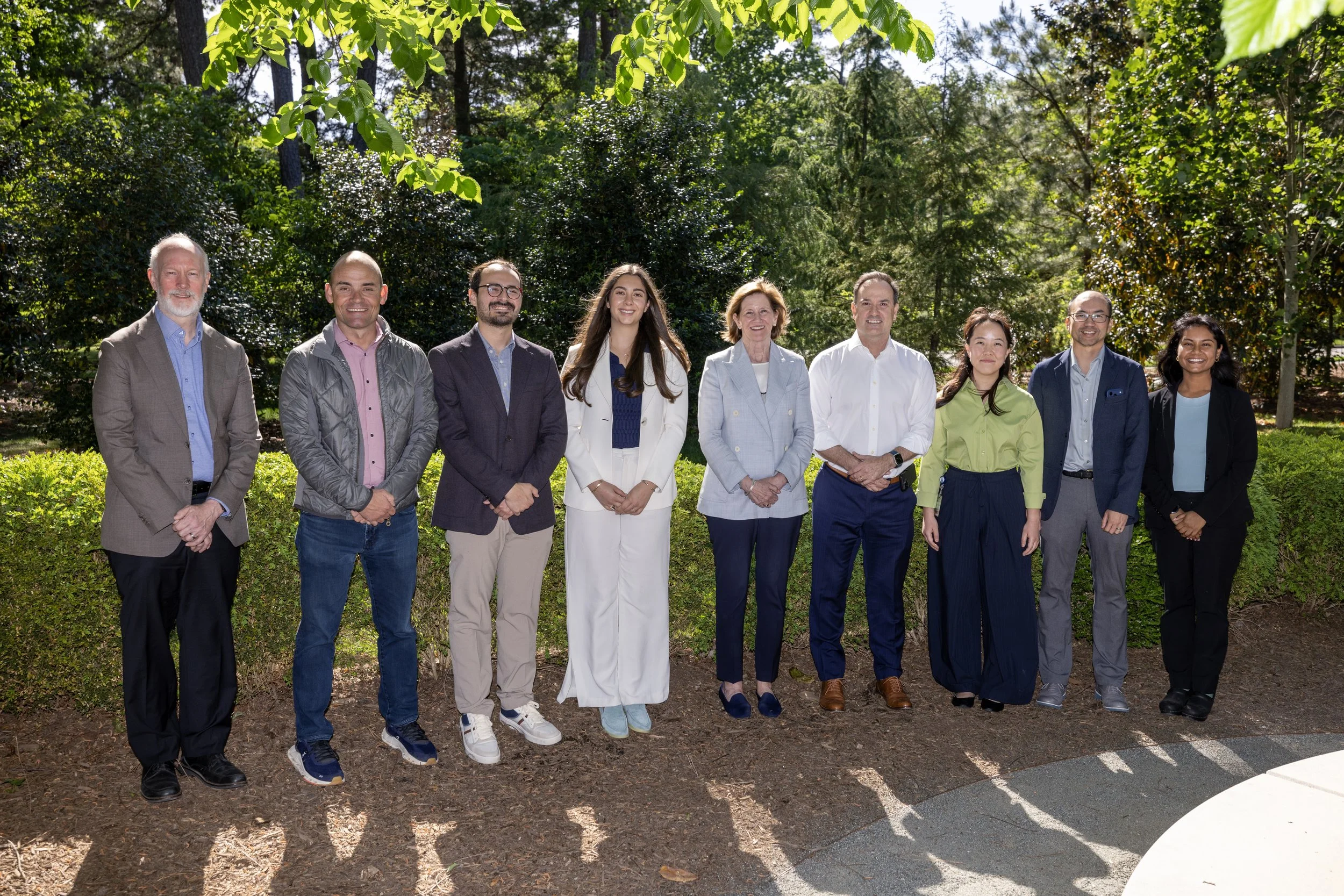 Colin Duckett, Charlie, Christian, Danai, Dean Klotman and three others posing outside. 