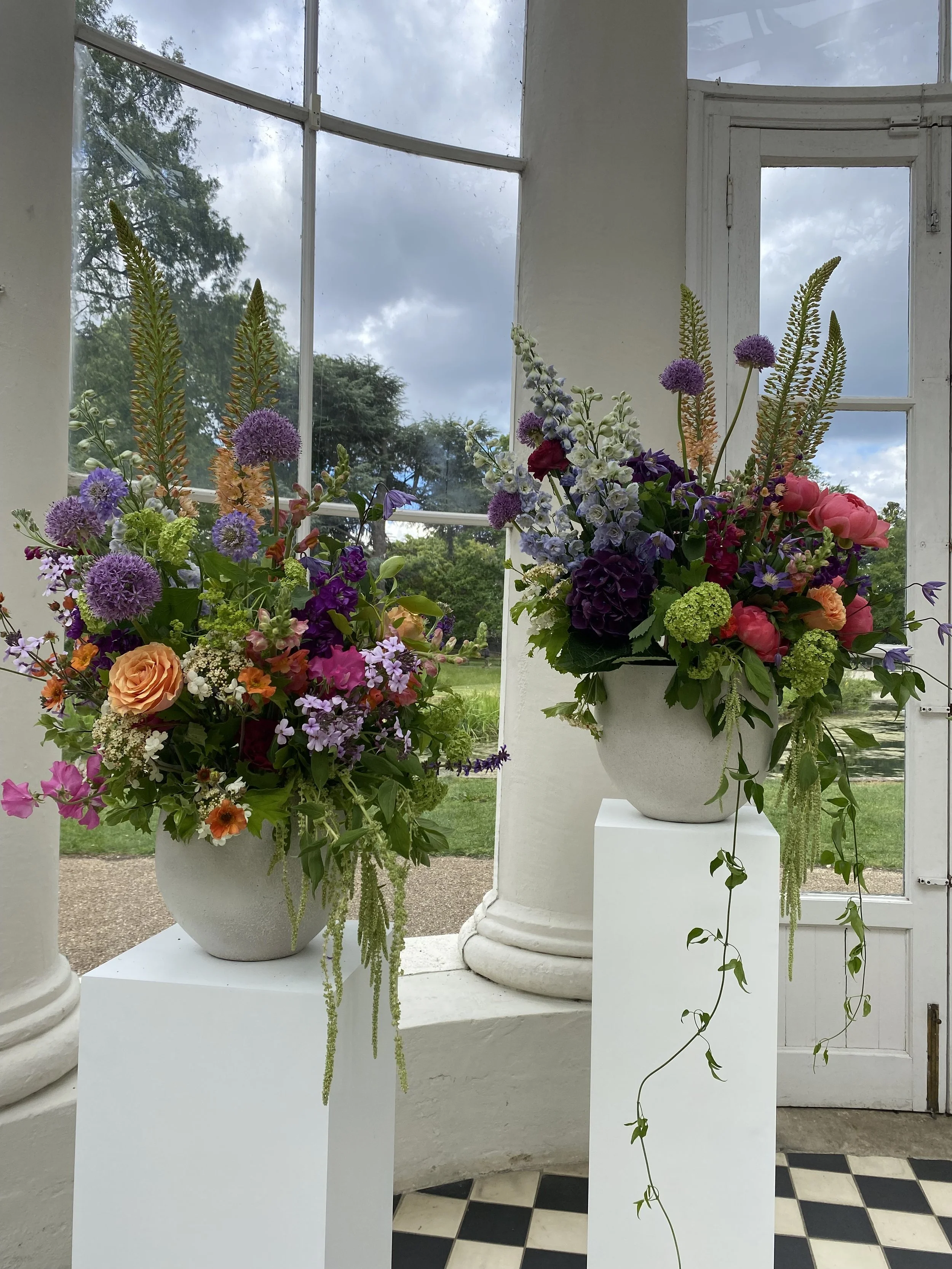 Bright and colourful ceremony flowers in the Orangery at Gunnersbury Park