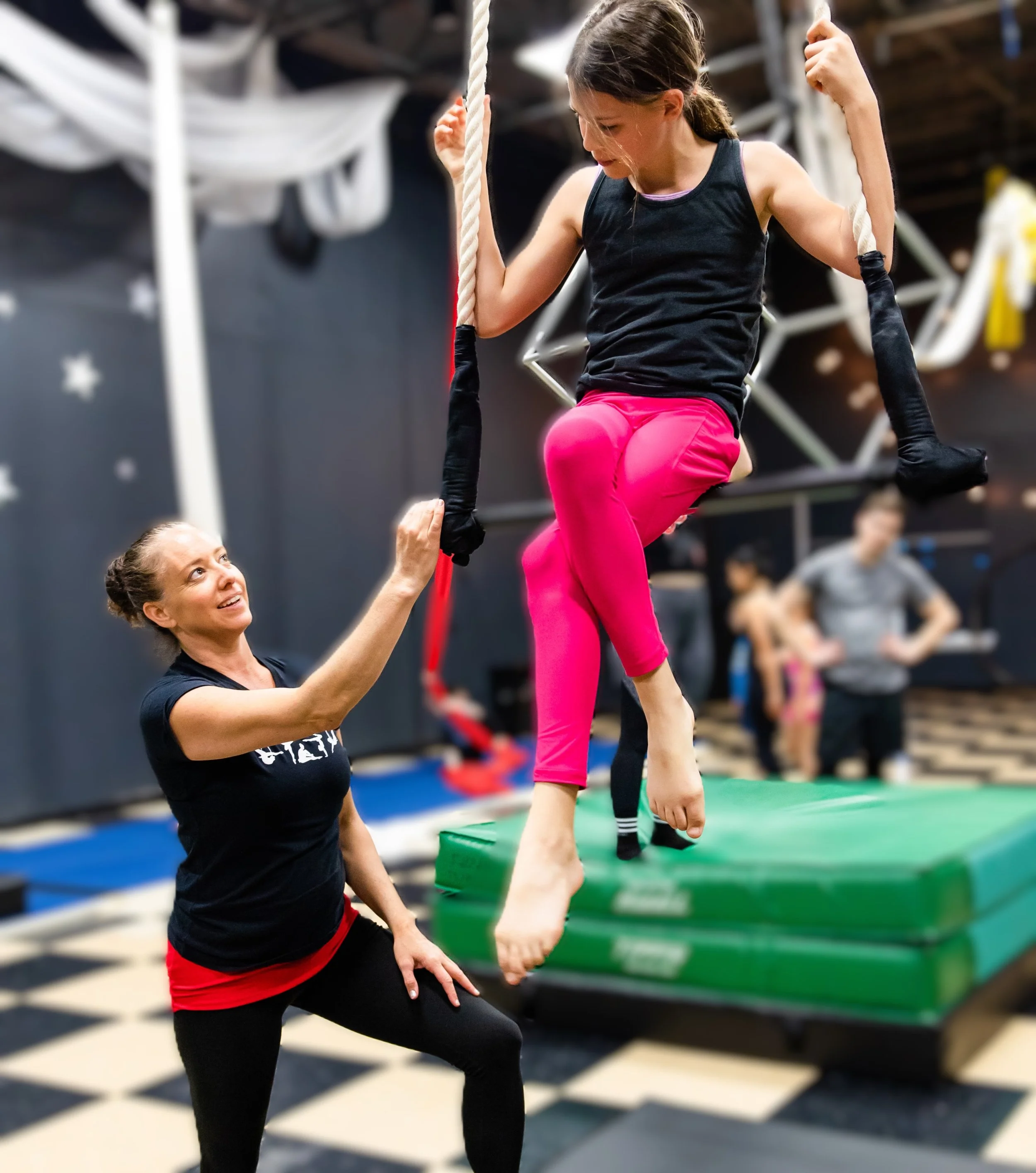 Coach with student on trapeze