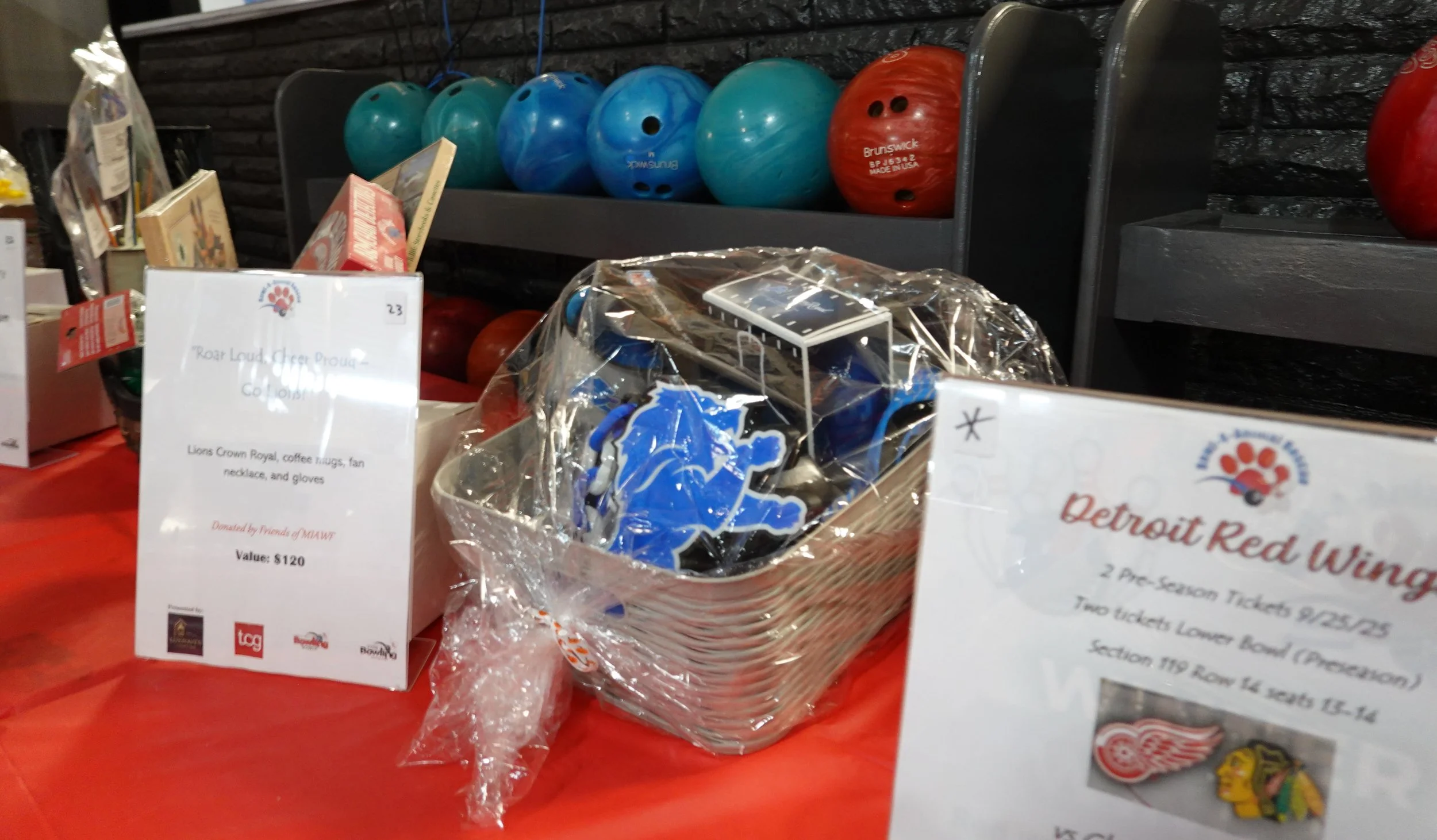 A Detroit Lions gift basket and bowling balls.