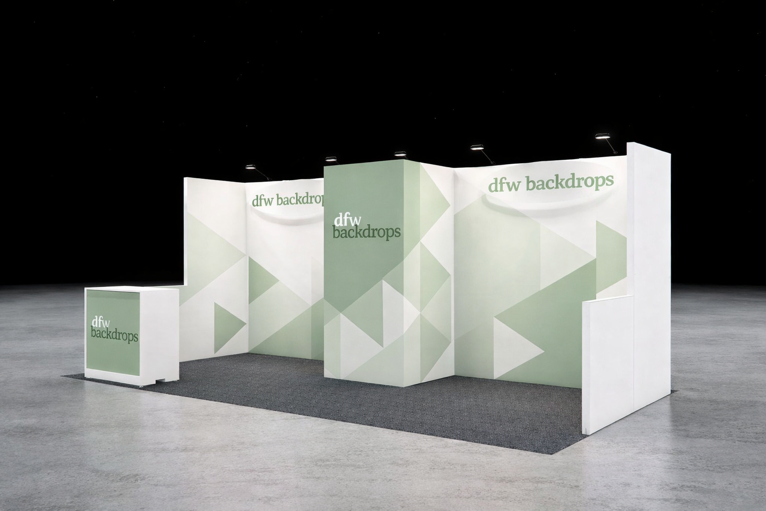 A booth with white and light green geometric patterned walls displaying 'dfw backdrops' at an event.