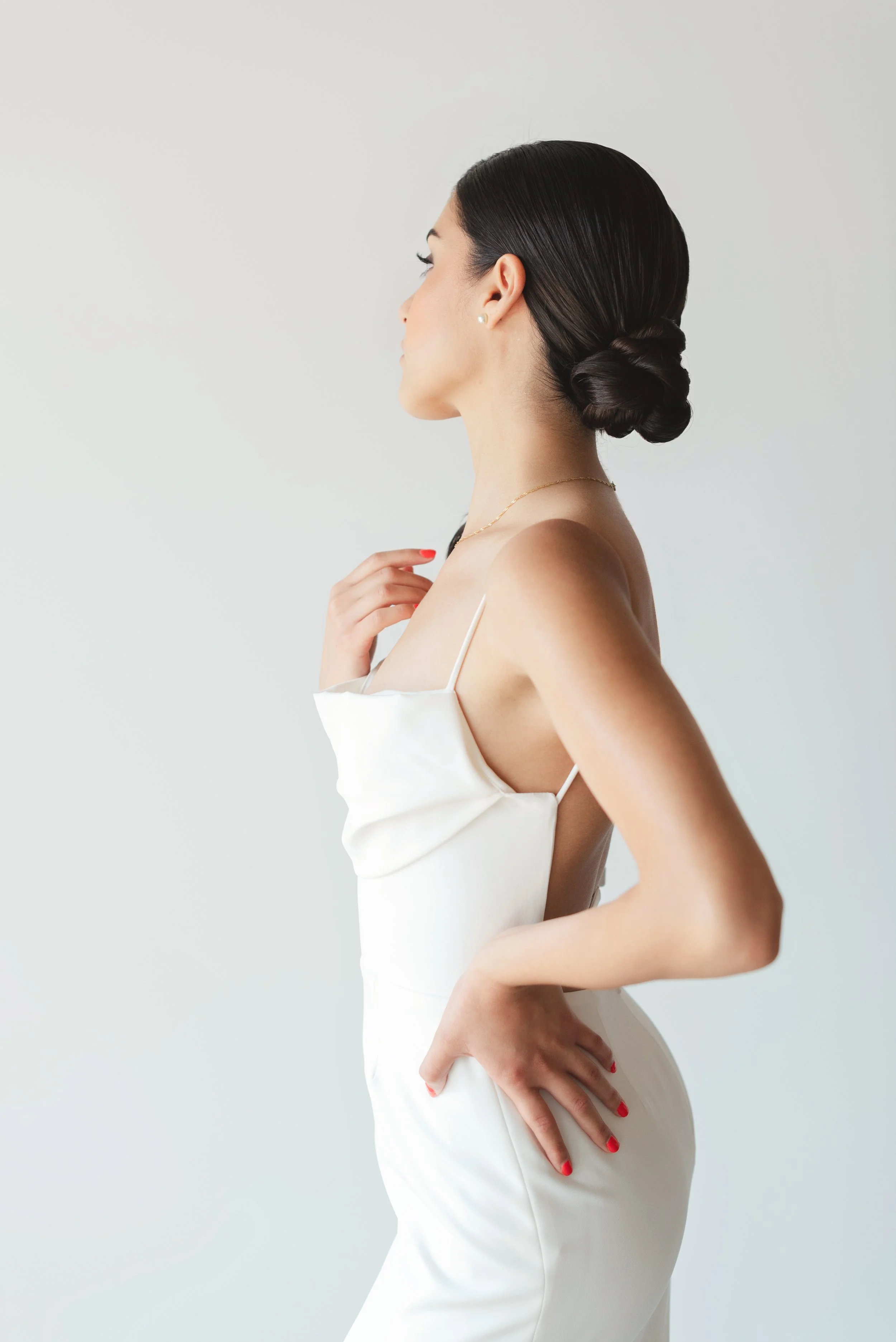 sleek bridal bun, wedding dress from Cande Bridal